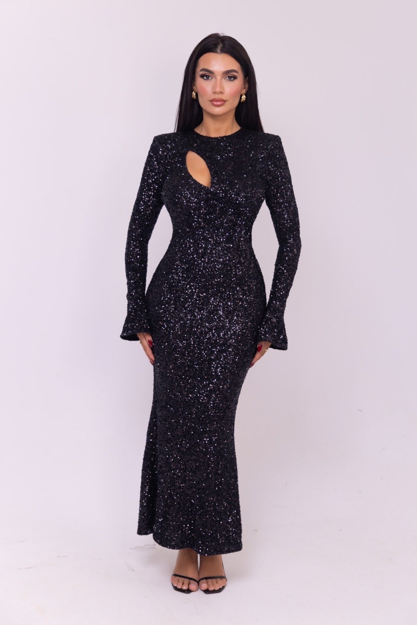 Full-length fitted black dress with a unique cutout design