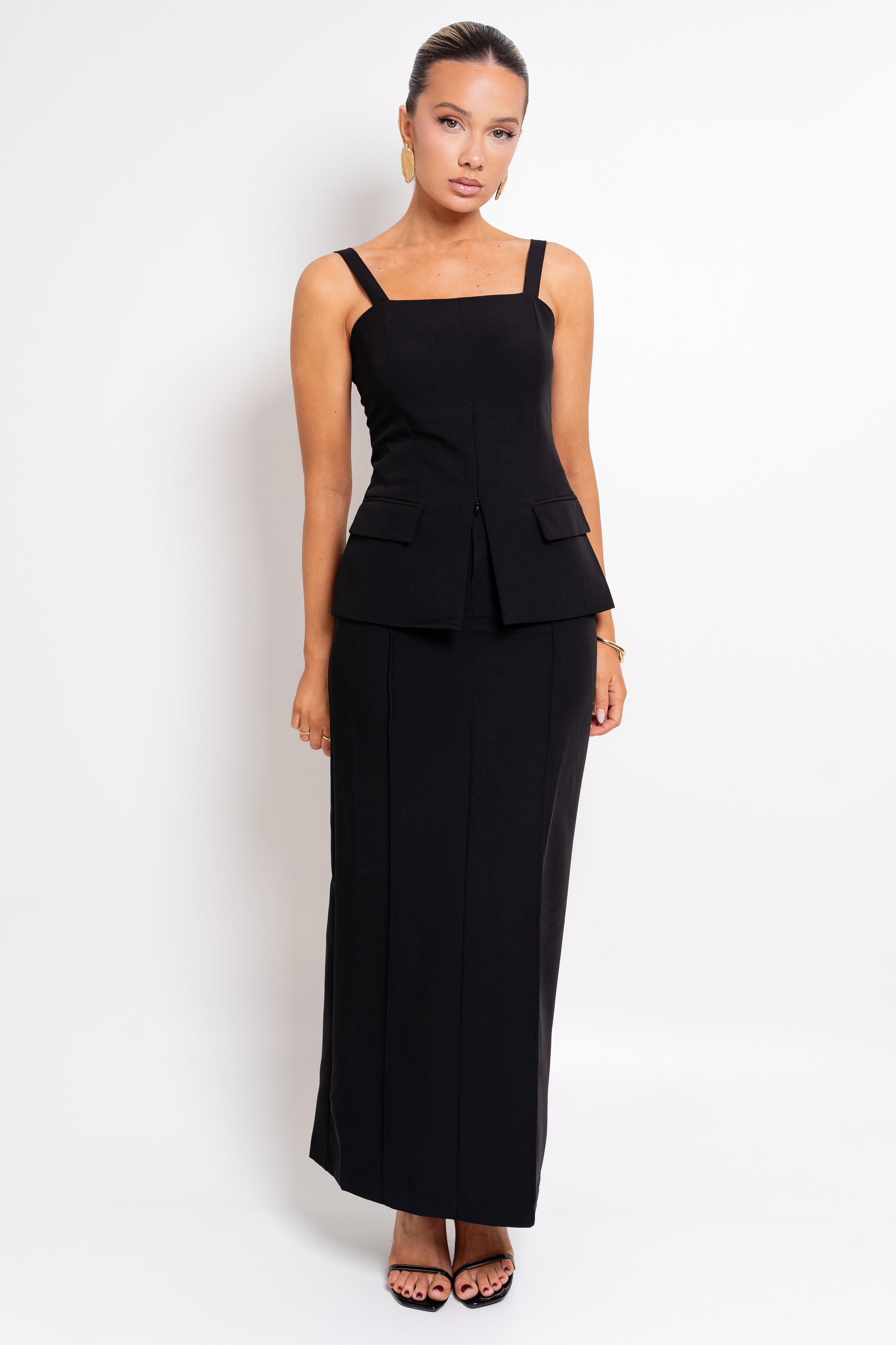 Black structured two-piece set with a fitted top and maxi skirt.