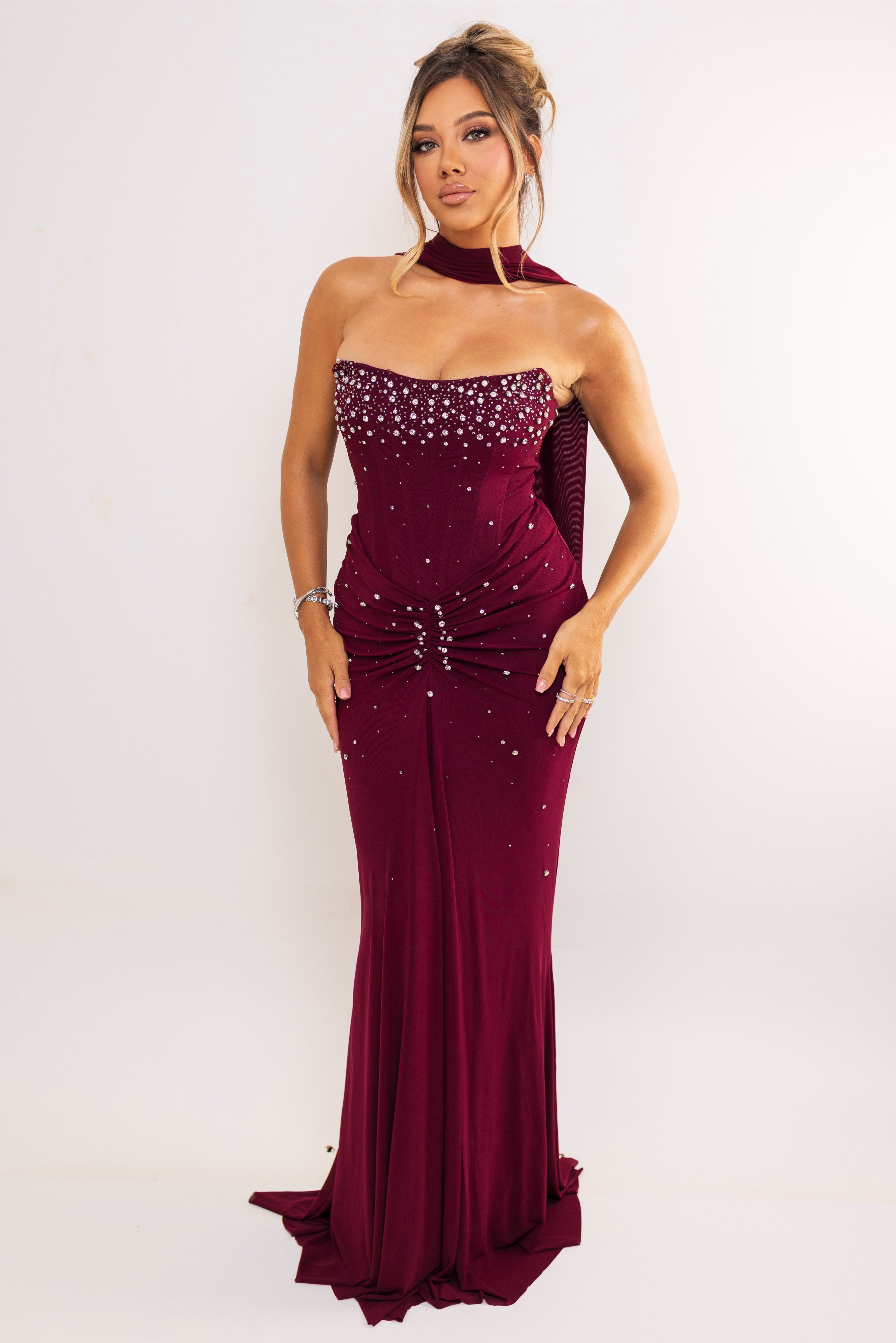 Front view of burgundy dress with ruched waist and sparkles.