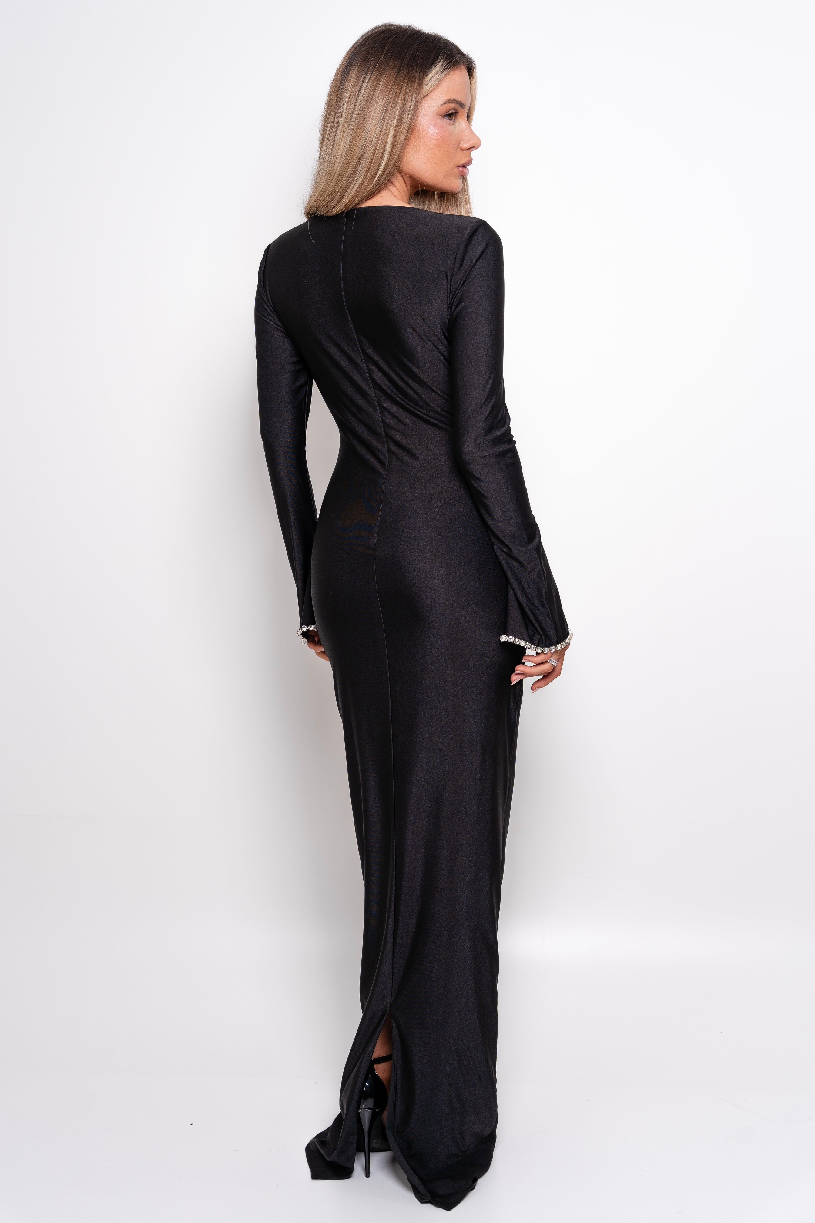 Modern black dress with a sweetheart neckline and elongated, elegant sleeves.