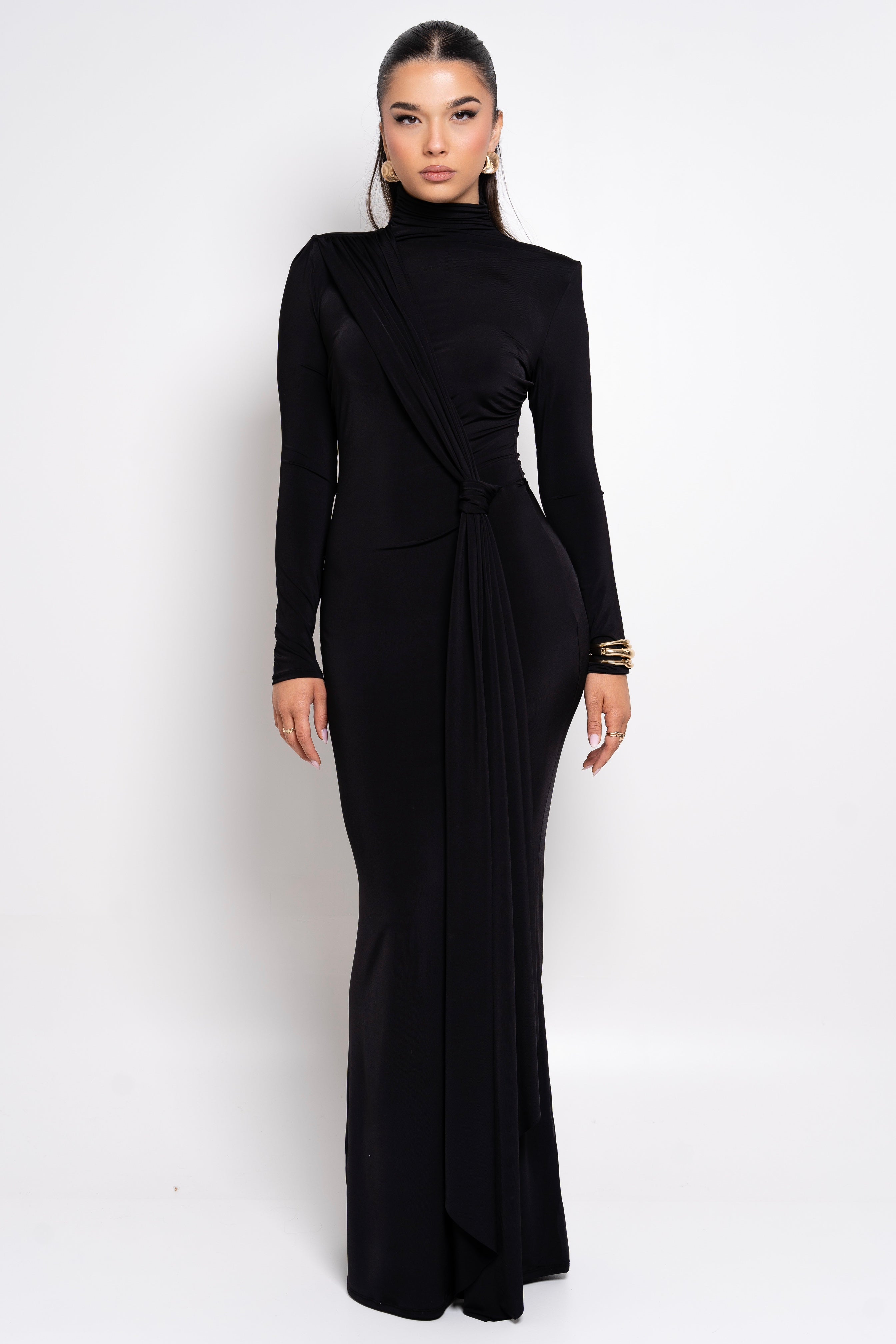 Chic black evening dress with a knotted waist accent and high-neck design.