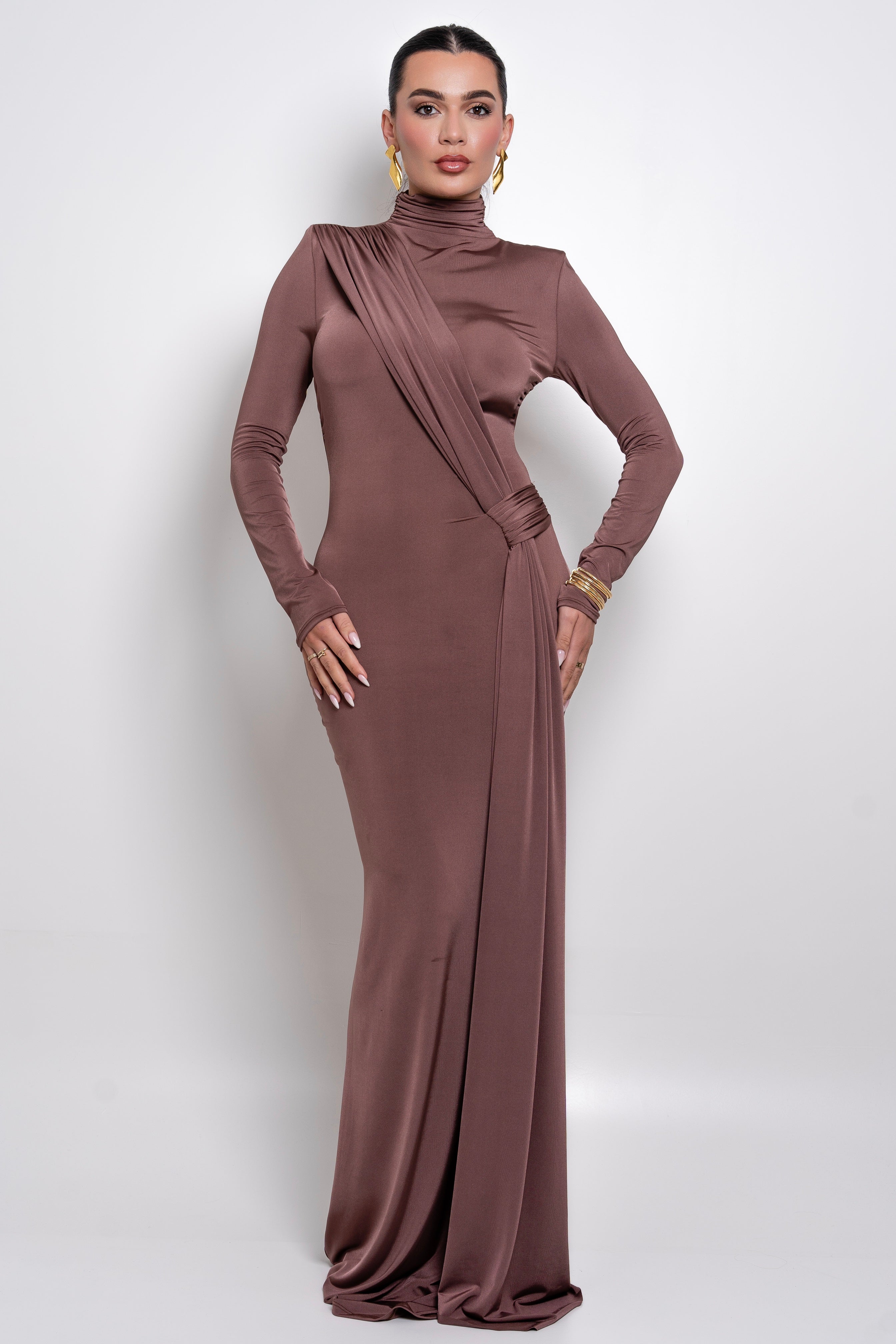 Refined floor-length gown in a rich coffee shade with a sculpted fit and draped accents.