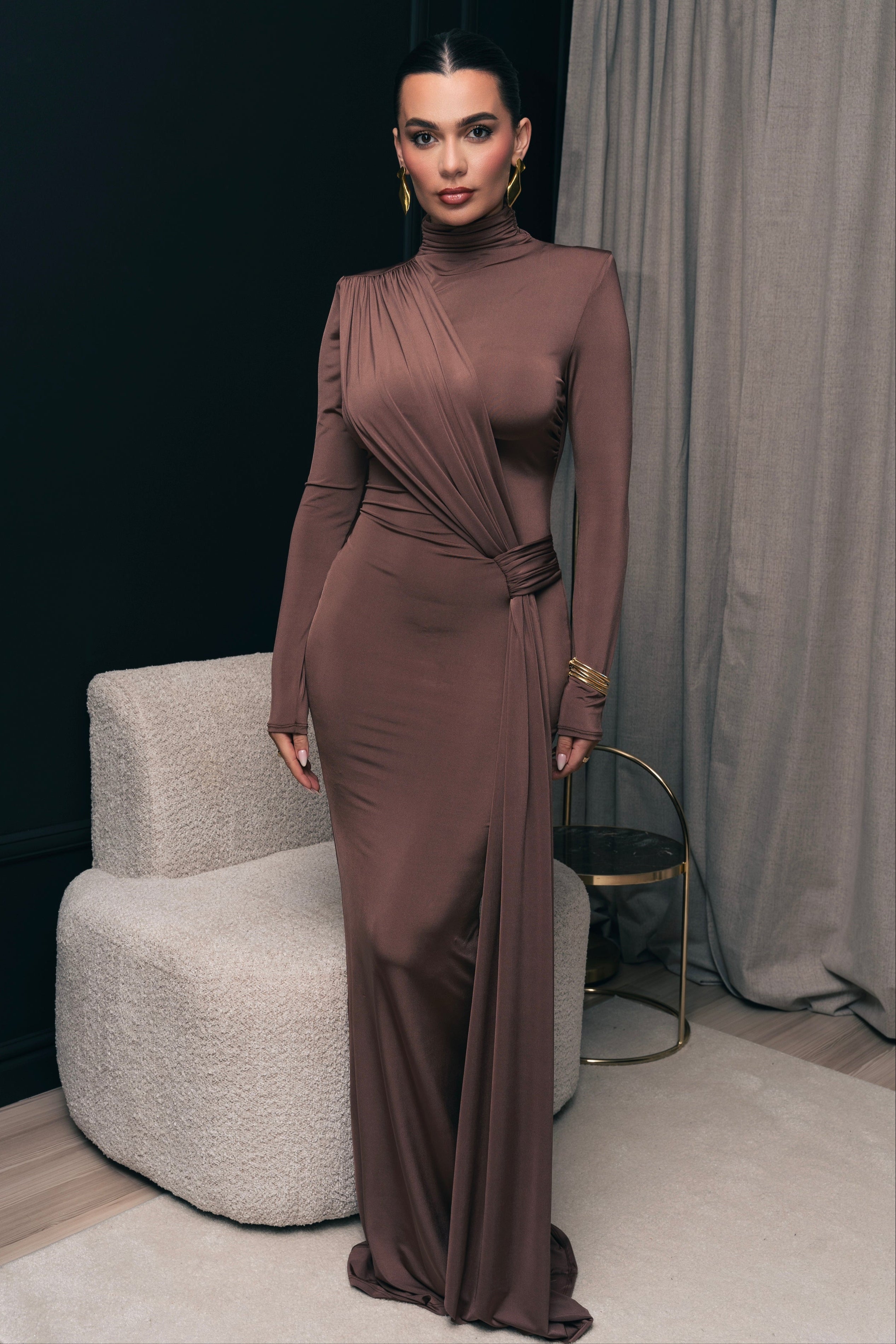 Full-length dress in a rich caffe tone, featuring long sleeves and a cinched waist.