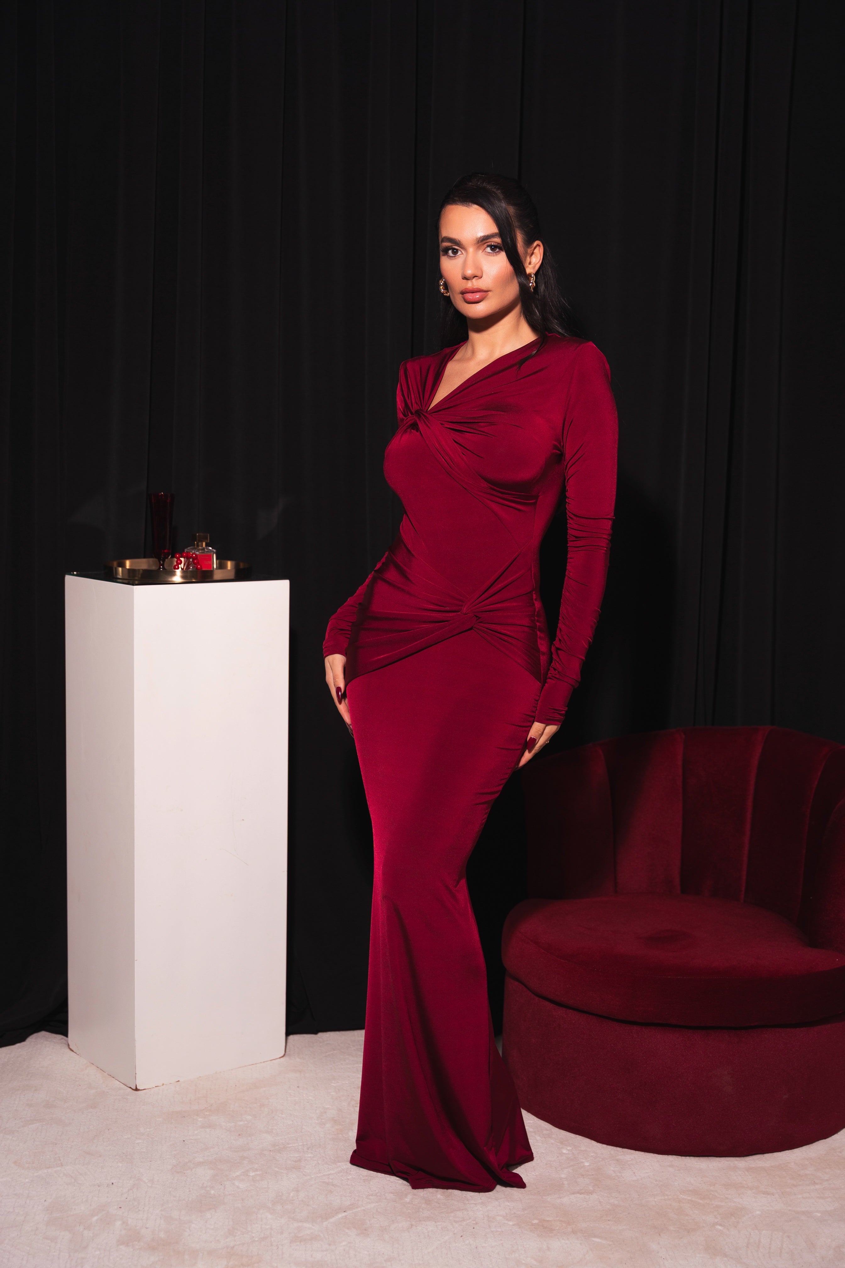 Chic red bodycon dress featuring a sophisticated knot detail at the waist and neckline