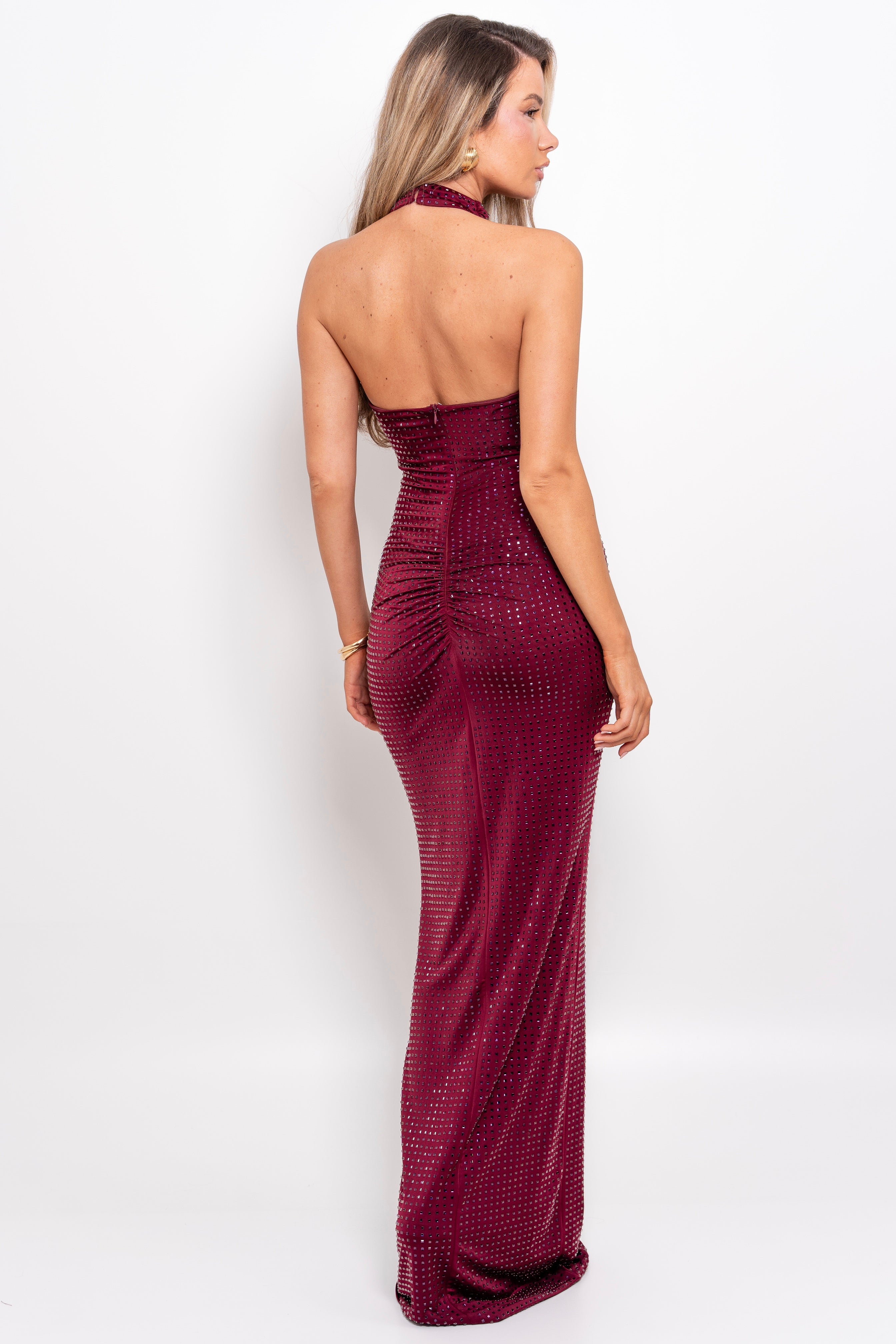 Rich burgundy evening gown with dazzling embellishments and an elegant halter cut.