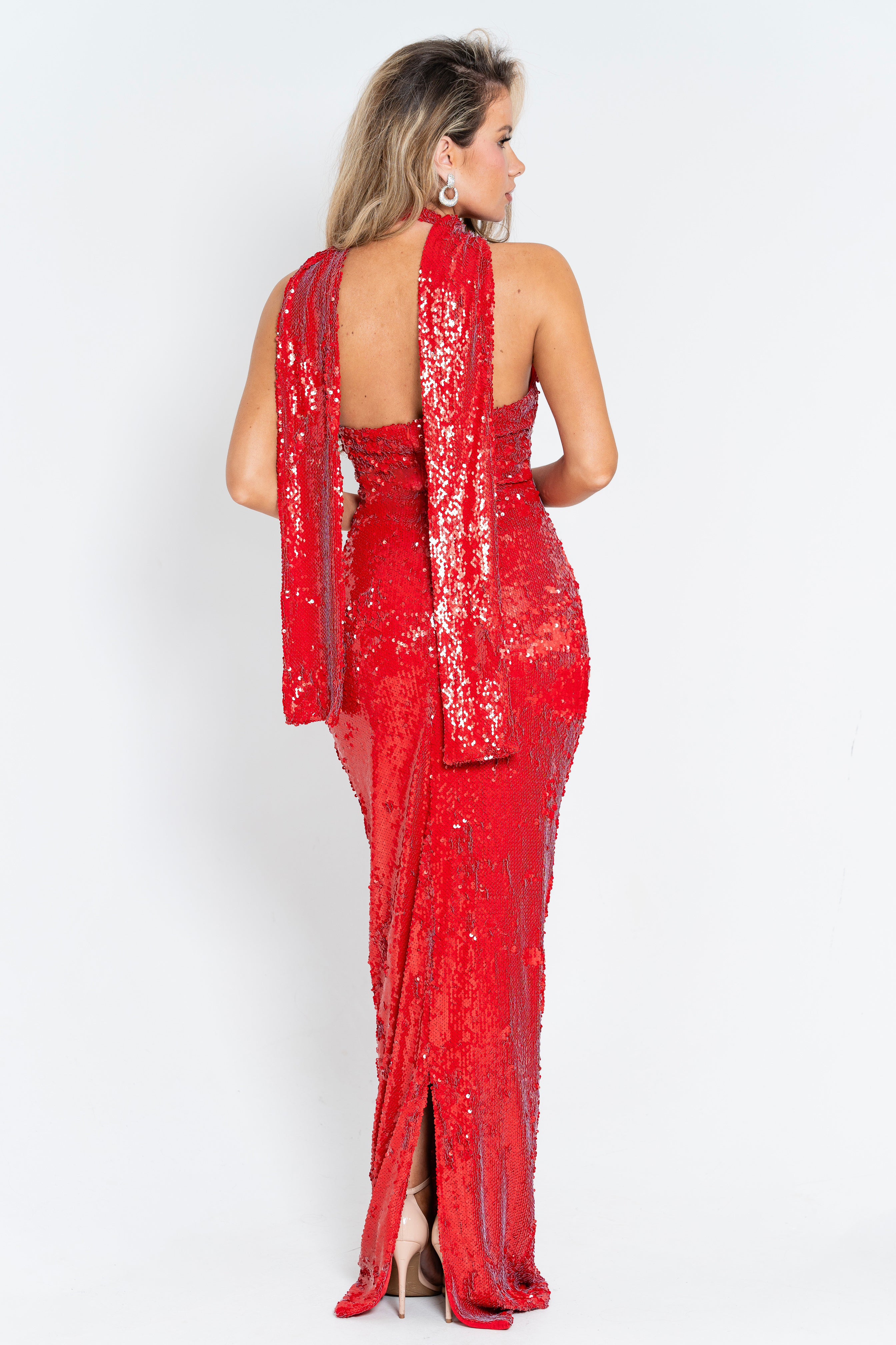 Stunning red evening dress with sparkling embellishments, a chic floral accent, and a sleek floor-length fit.