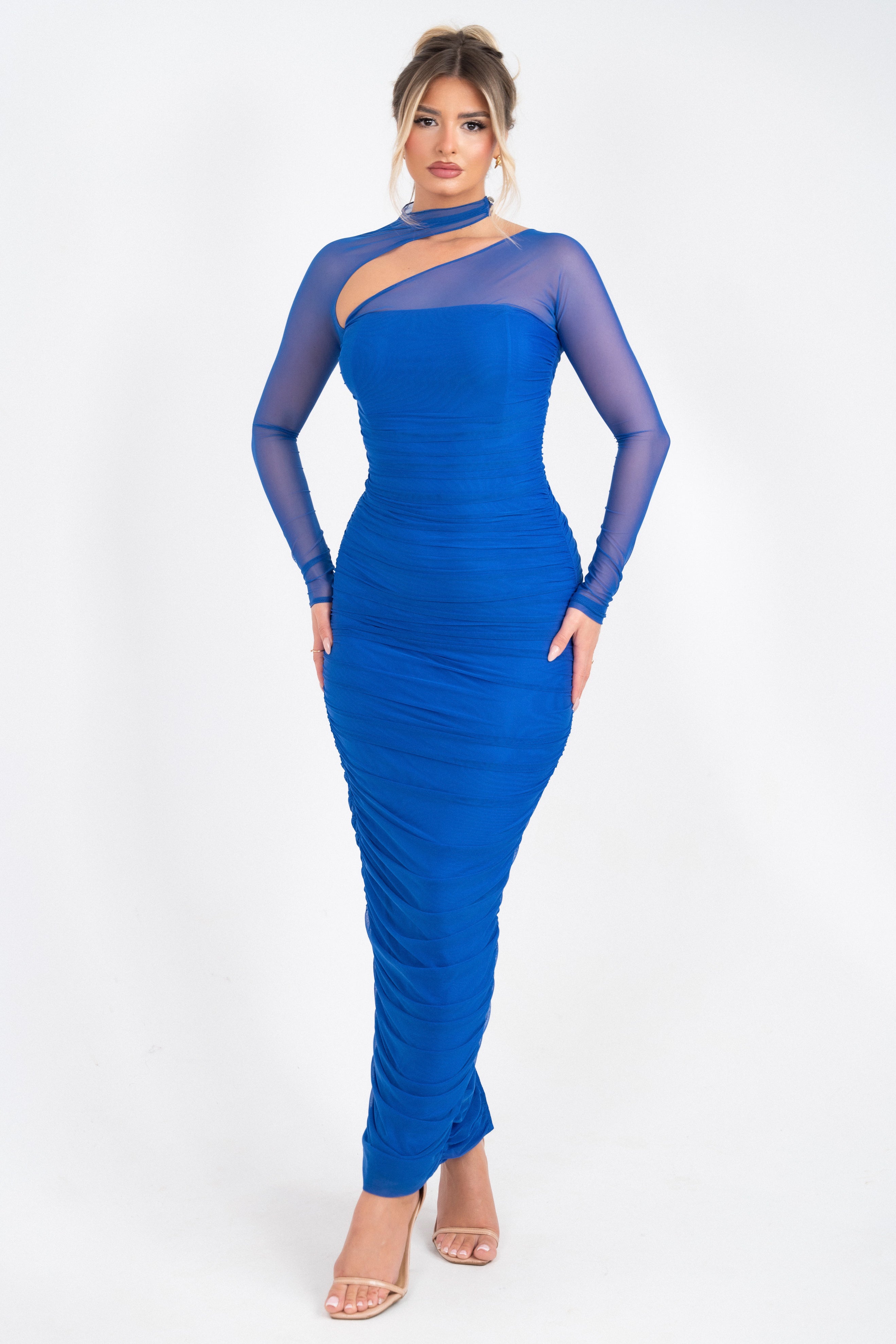 Royal blue dress with an asymmetrical neckline and sheer long sleeves.