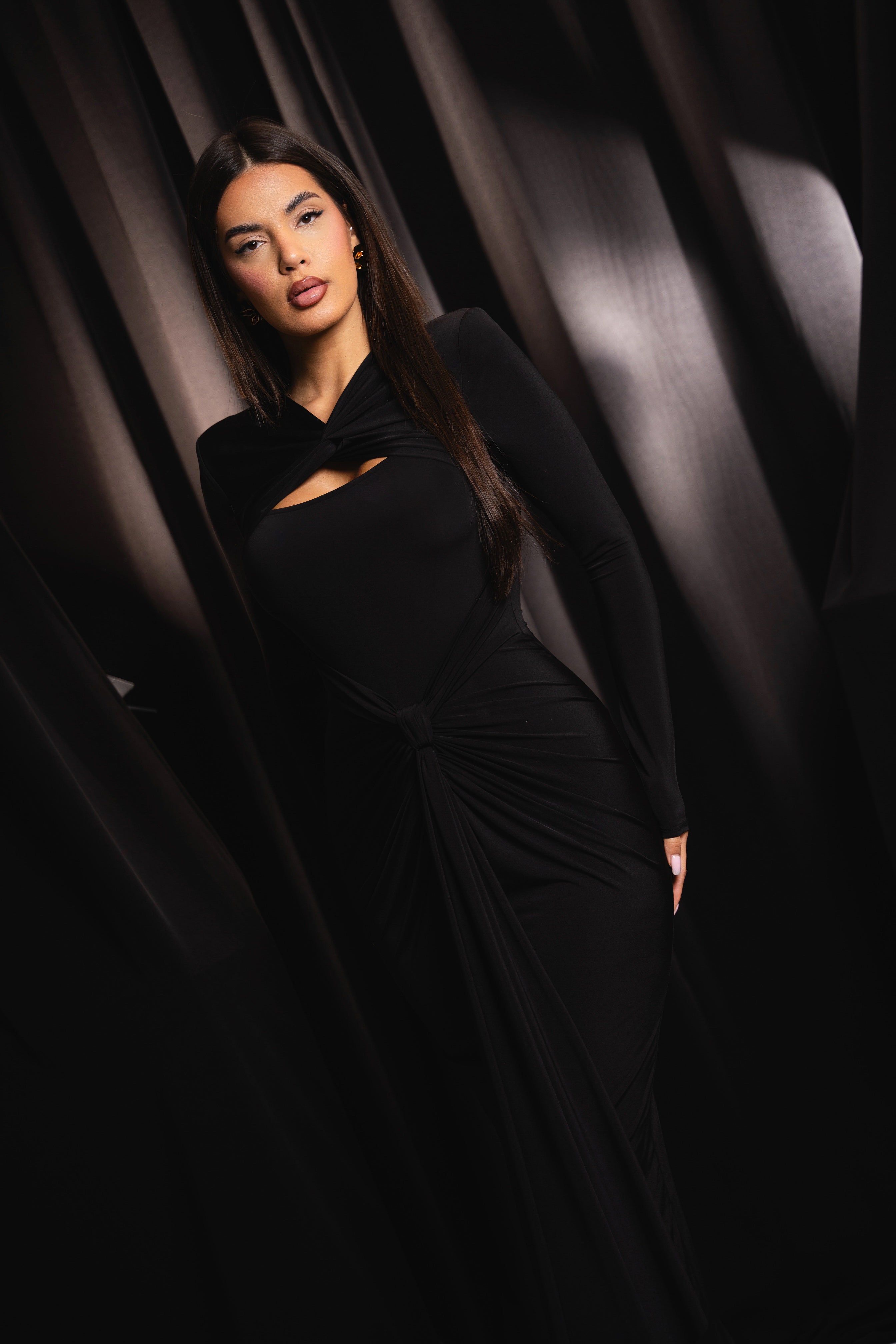 Long black dress with bold tailoring and a statement neckline