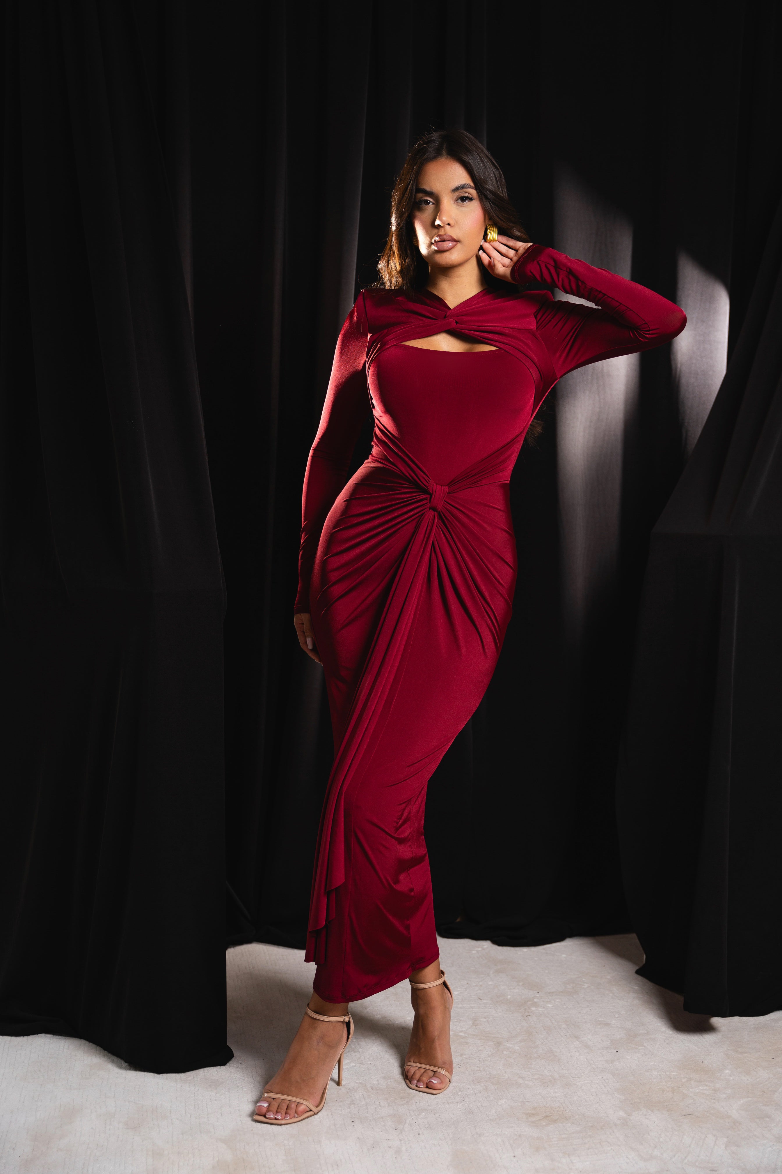 Bold burgundy dress with a dramatic front knot design