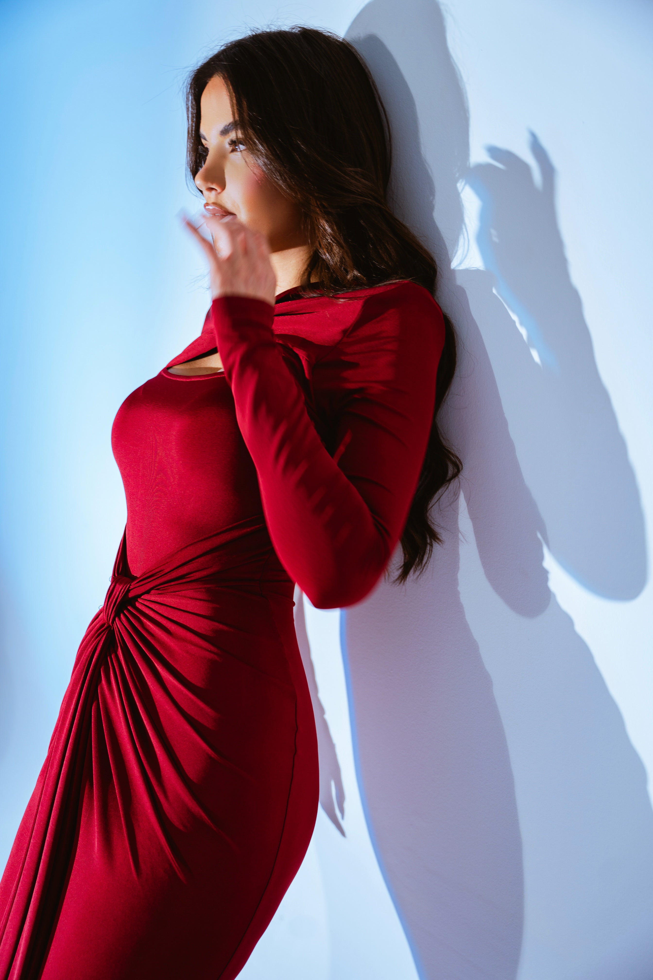 Full-length burgundy gown with an asymmetrical waist detail