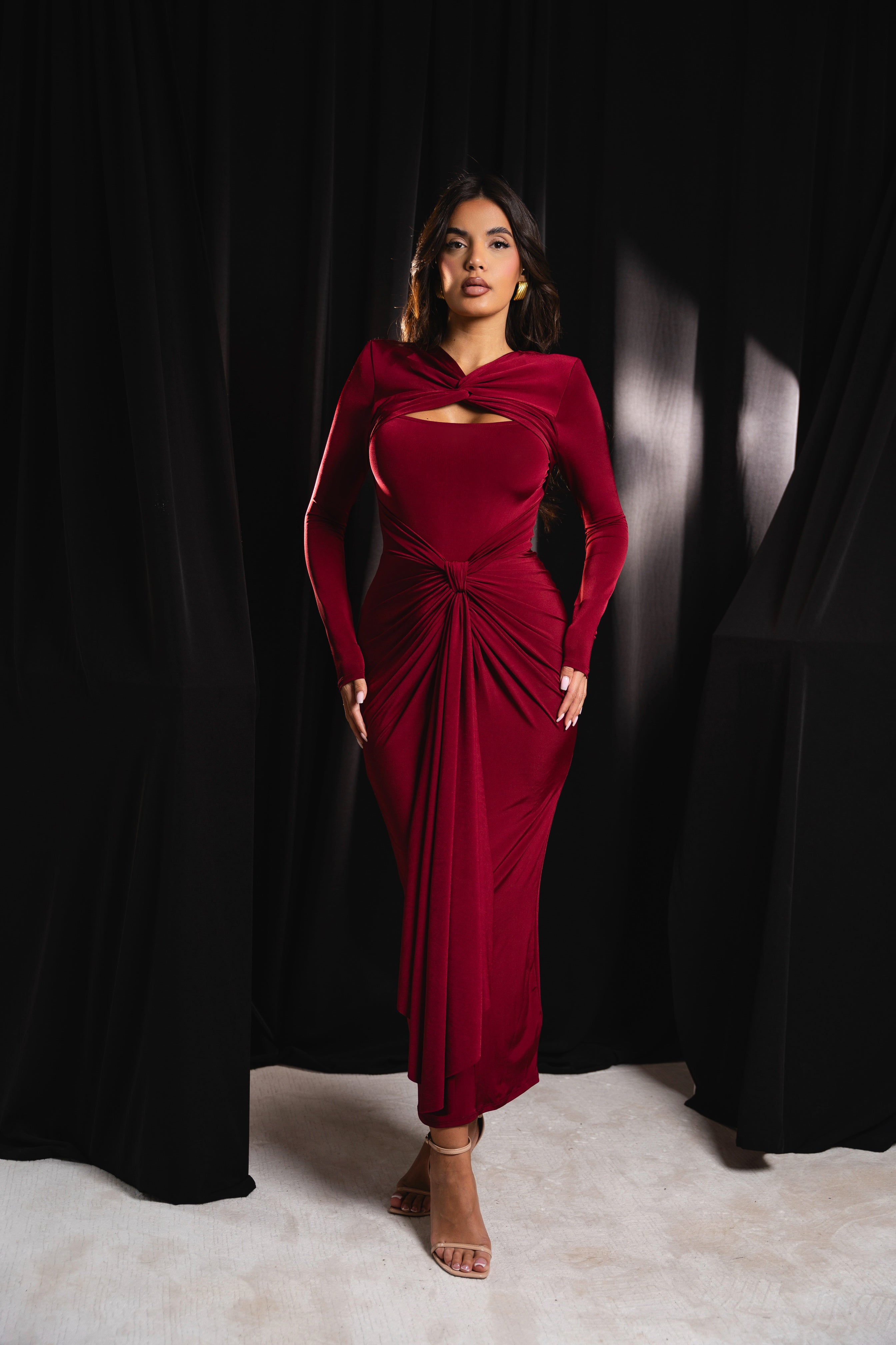 Chic burgundy gown with a sophisticated gathered waist and unique neckline