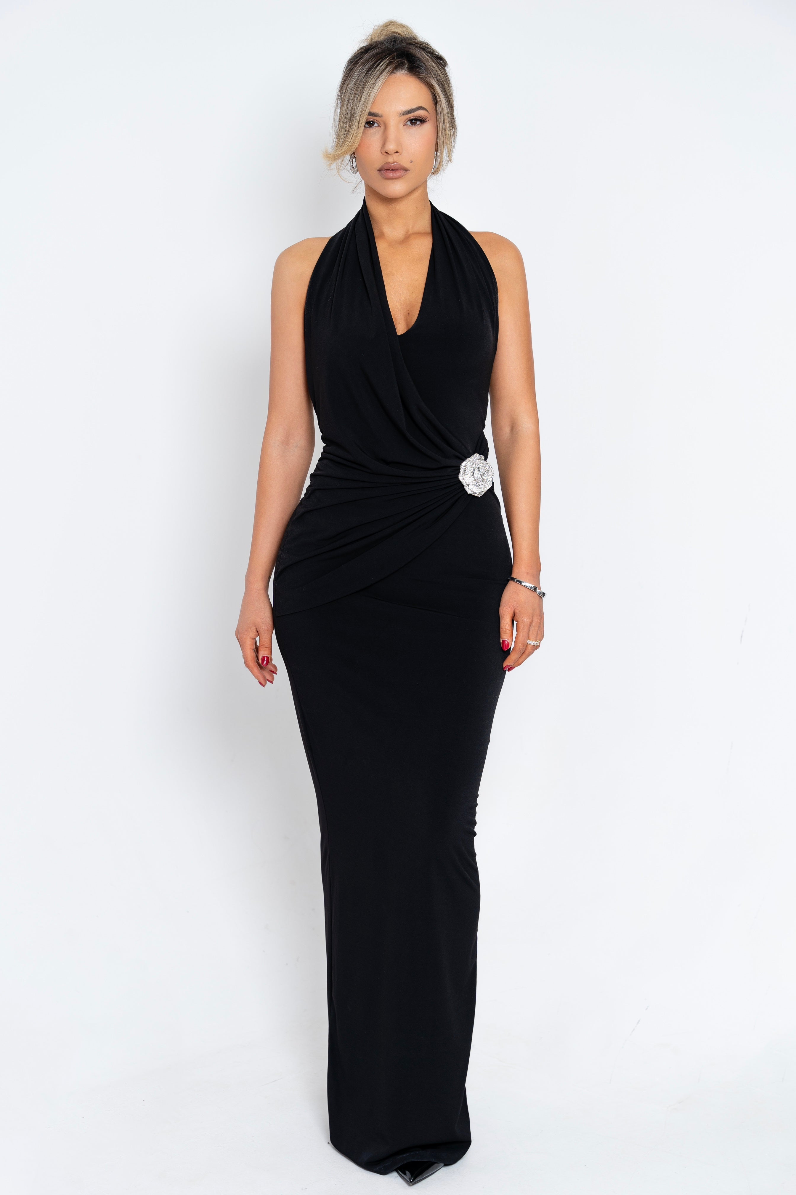 Chic black gown showcasing a halter neck design, fitted bodice, and shimmering side embellishment for a luxurious touch.