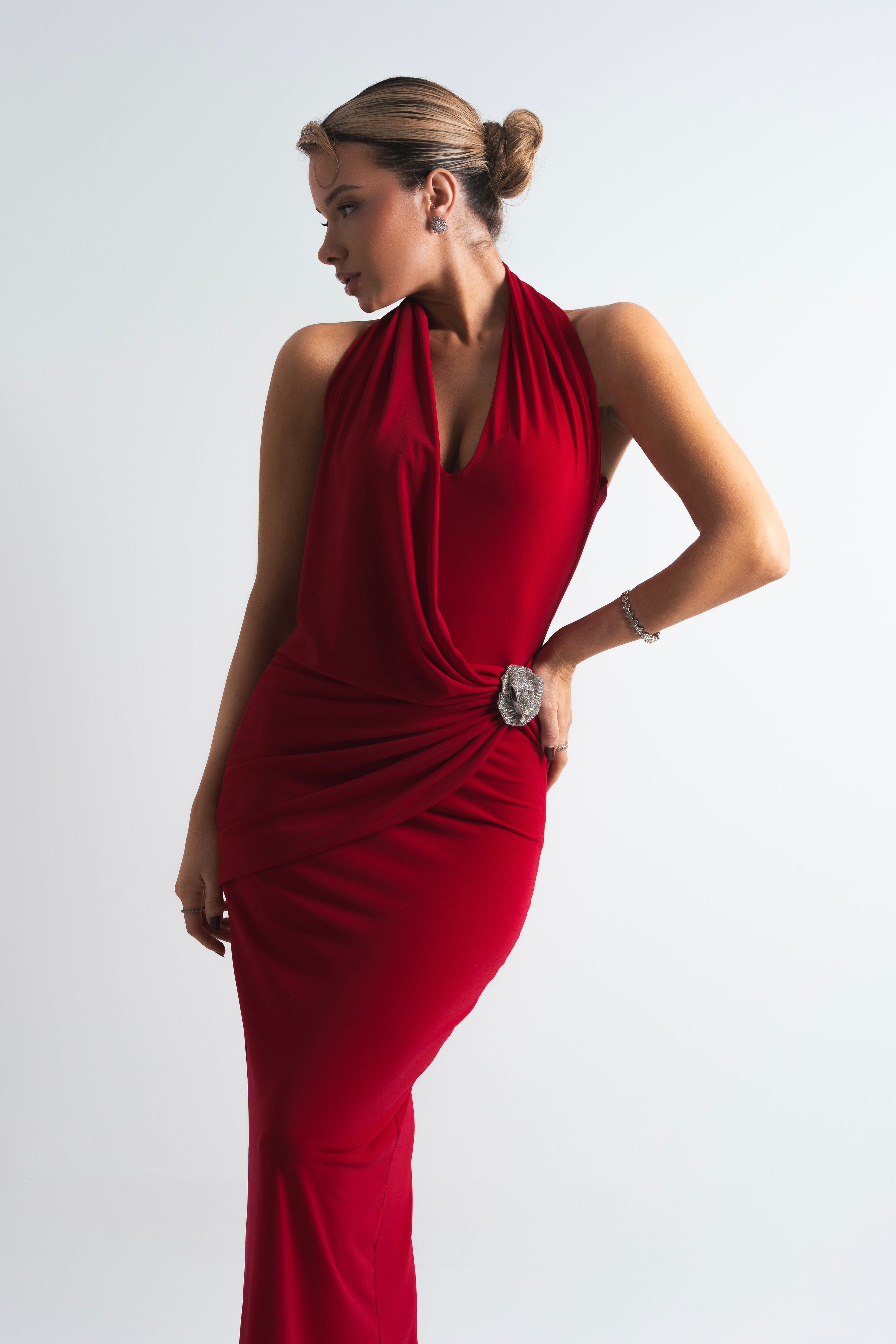 Stunning red dress with a figure-hugging silhouette, glamorous side embellishment, and an open back for a confident statement.