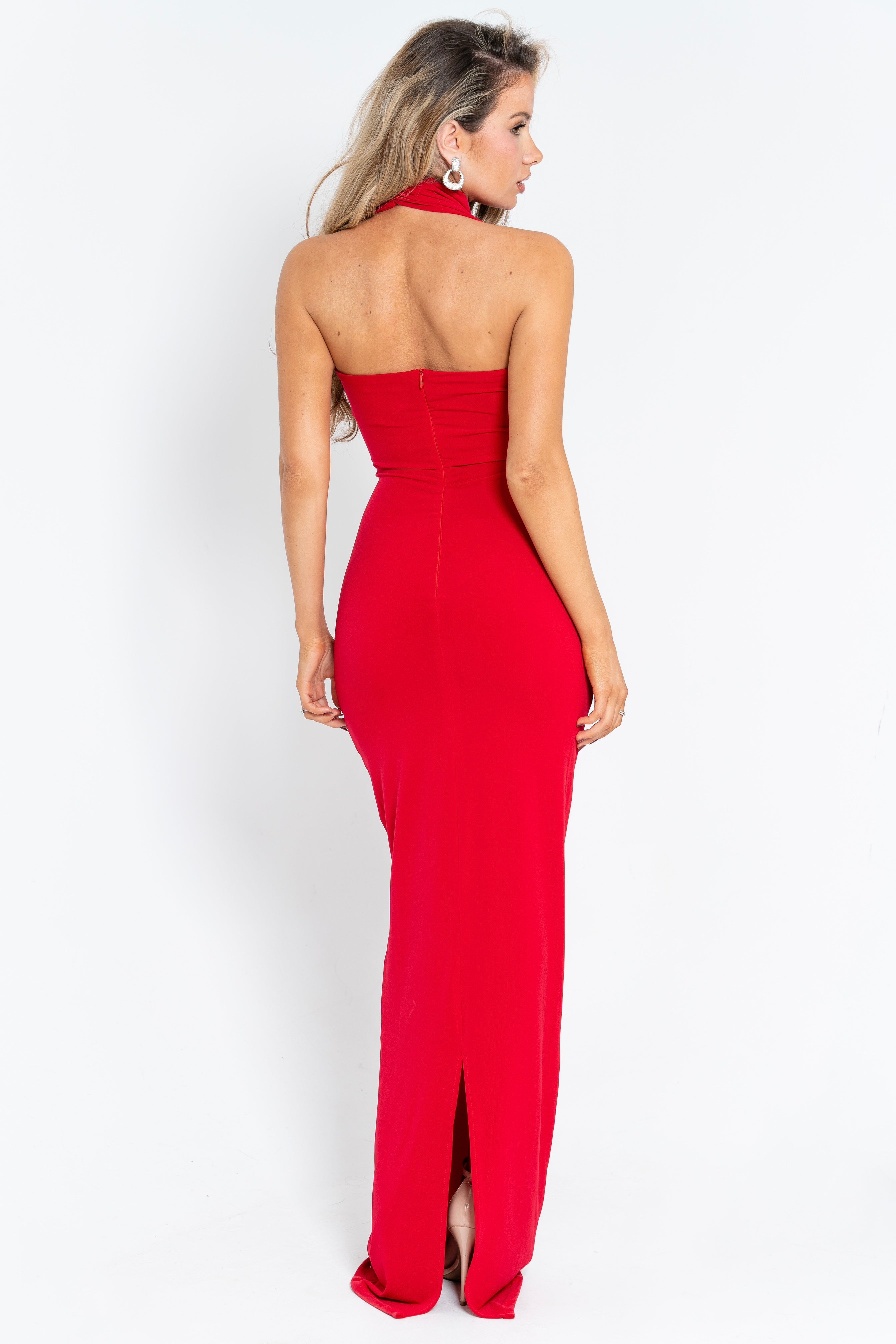 Vibrant red dress featuring a draped waist, side embellishment, and a dramatic open-back design for a bold statement.