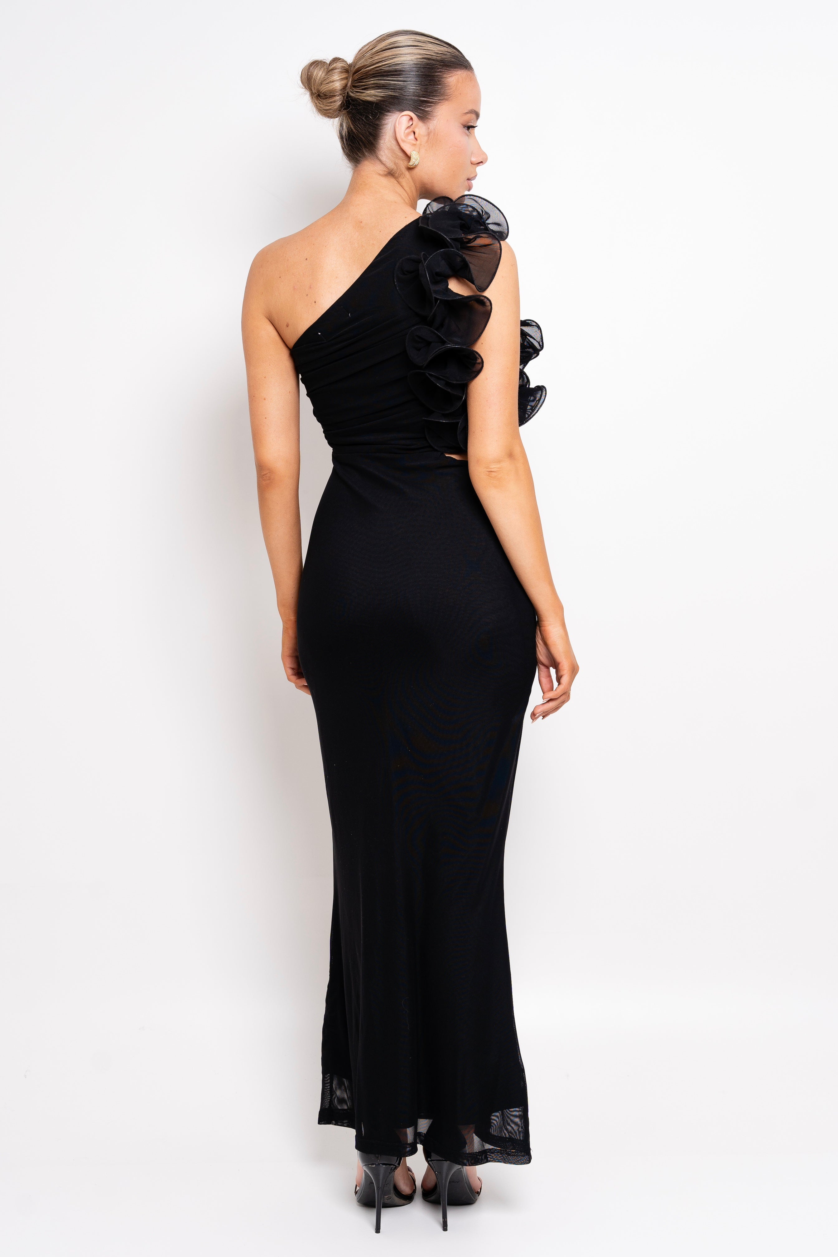 Classy black gown with draped details and a feminine touch.