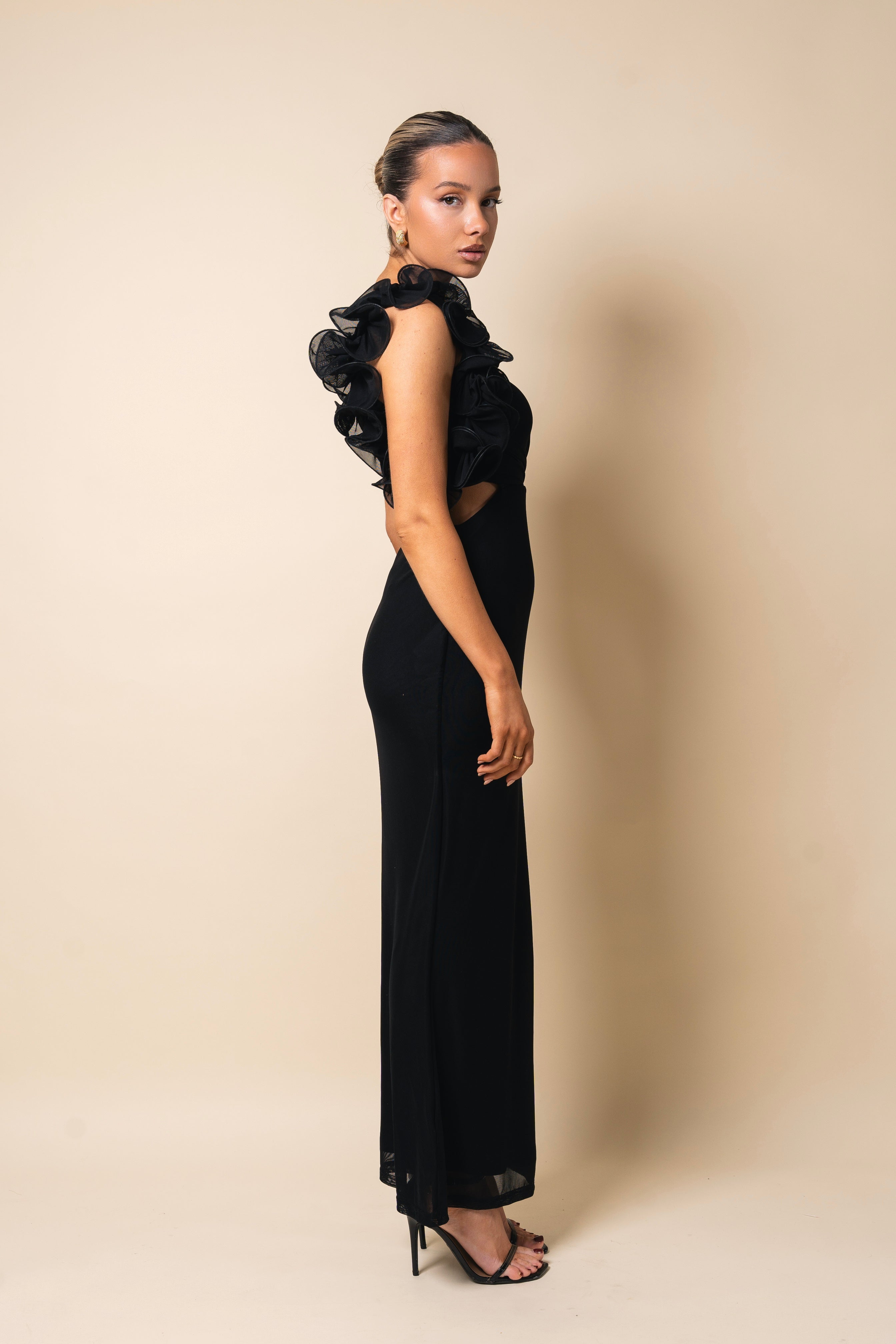 Chic asymmetrical black evening gown with a fitted silhouette.