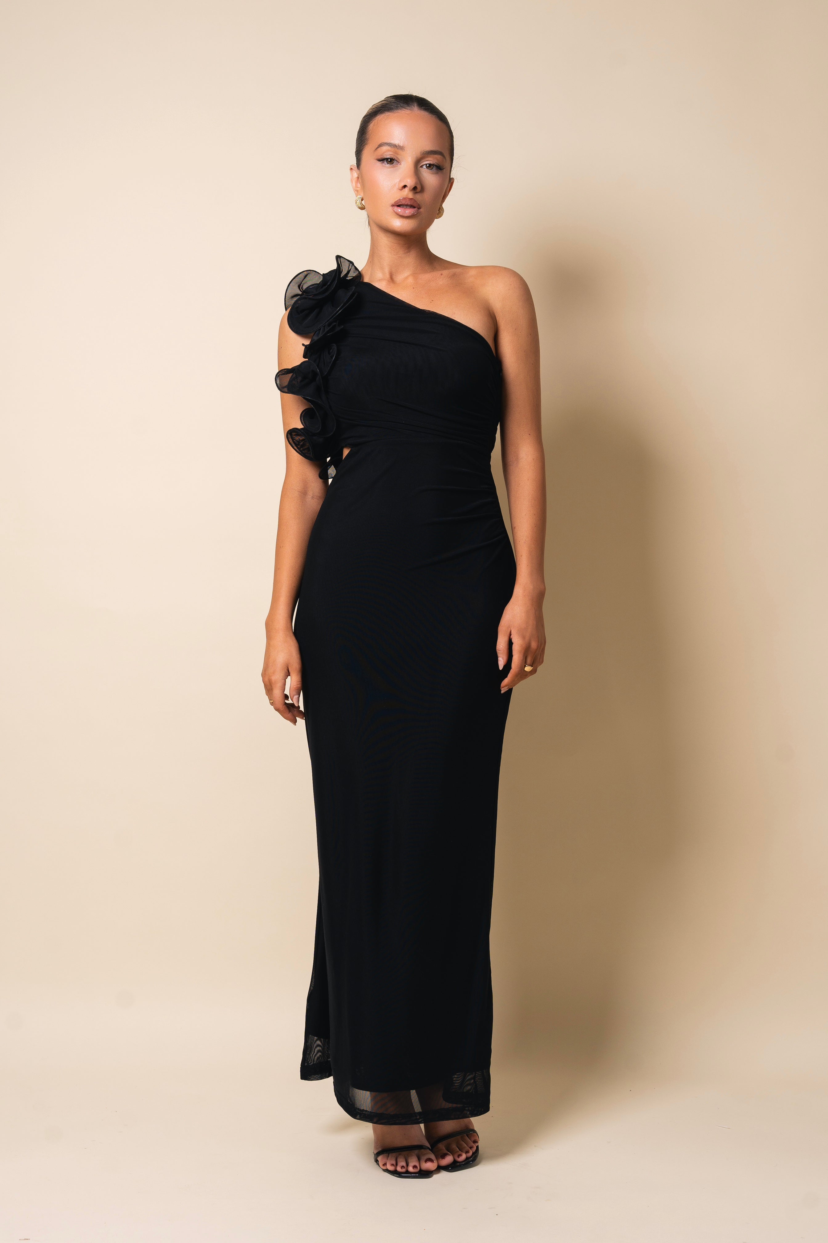 Stylish black formal dress featuring a floral shoulder accent.