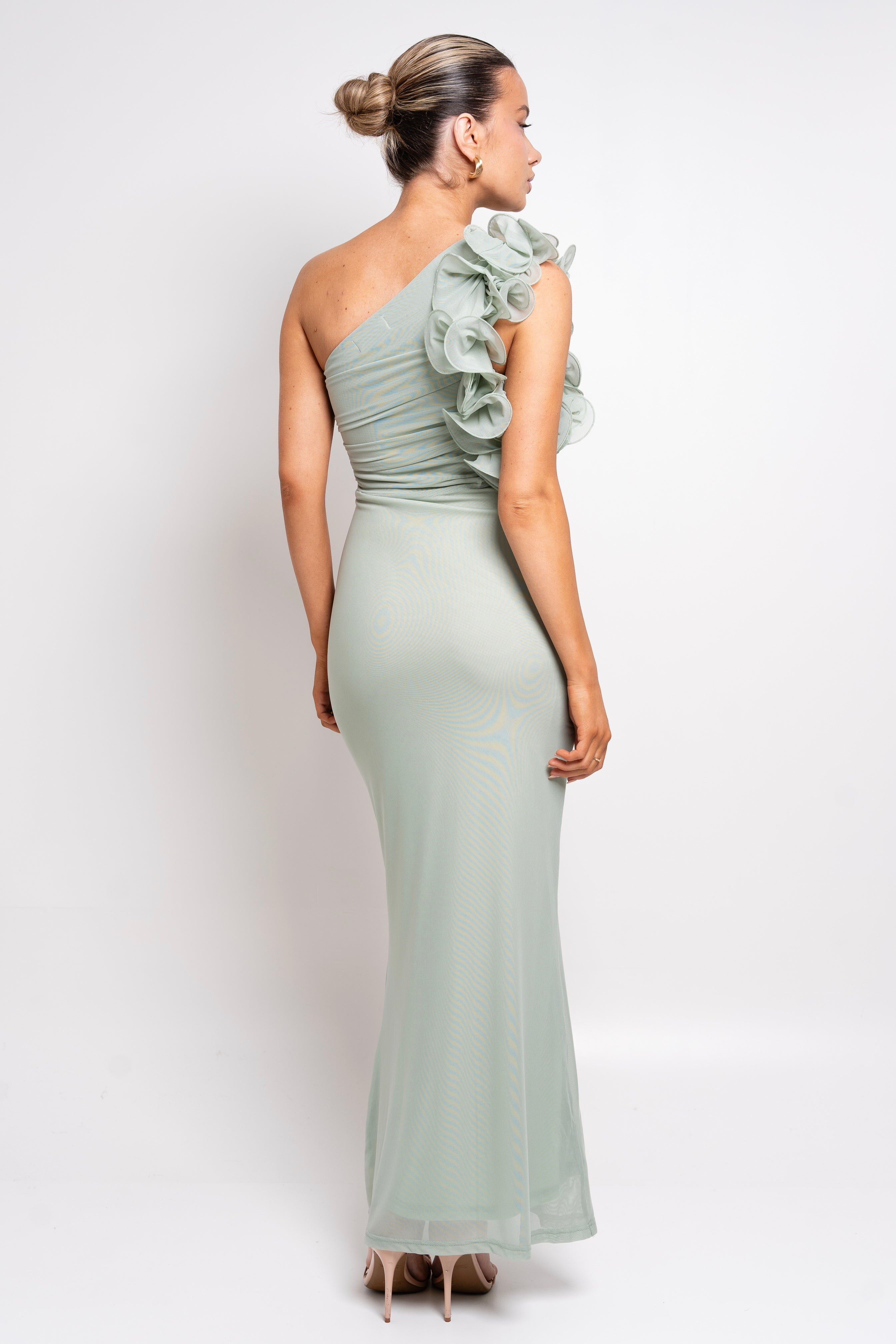 Floor-length sage dress with a feminine silhouette and ruffled shoulder.