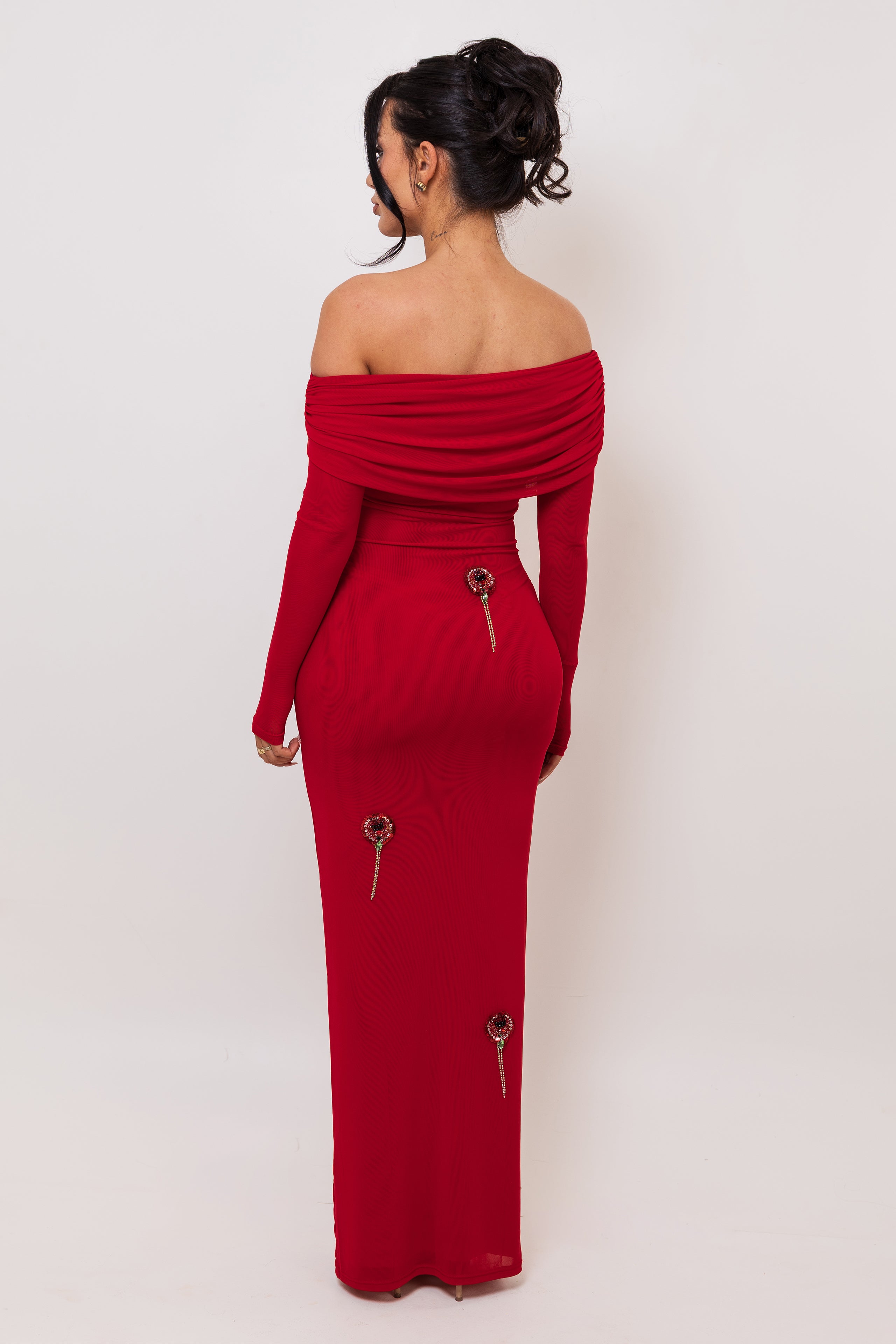 Red off-shoulder dress with gold buttons on a white background