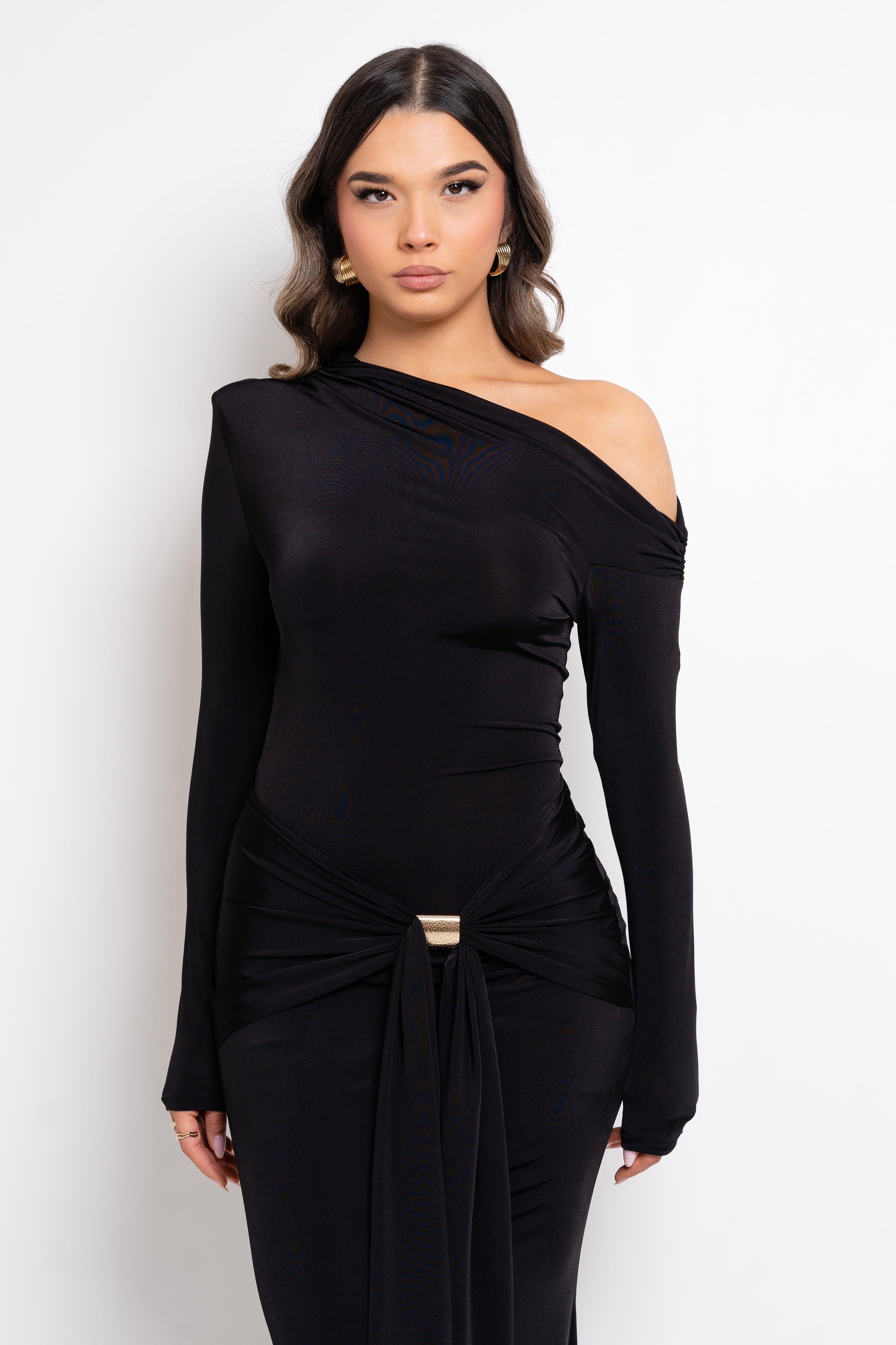 Model in a sleek black dress featuring a stylish knot at the waist