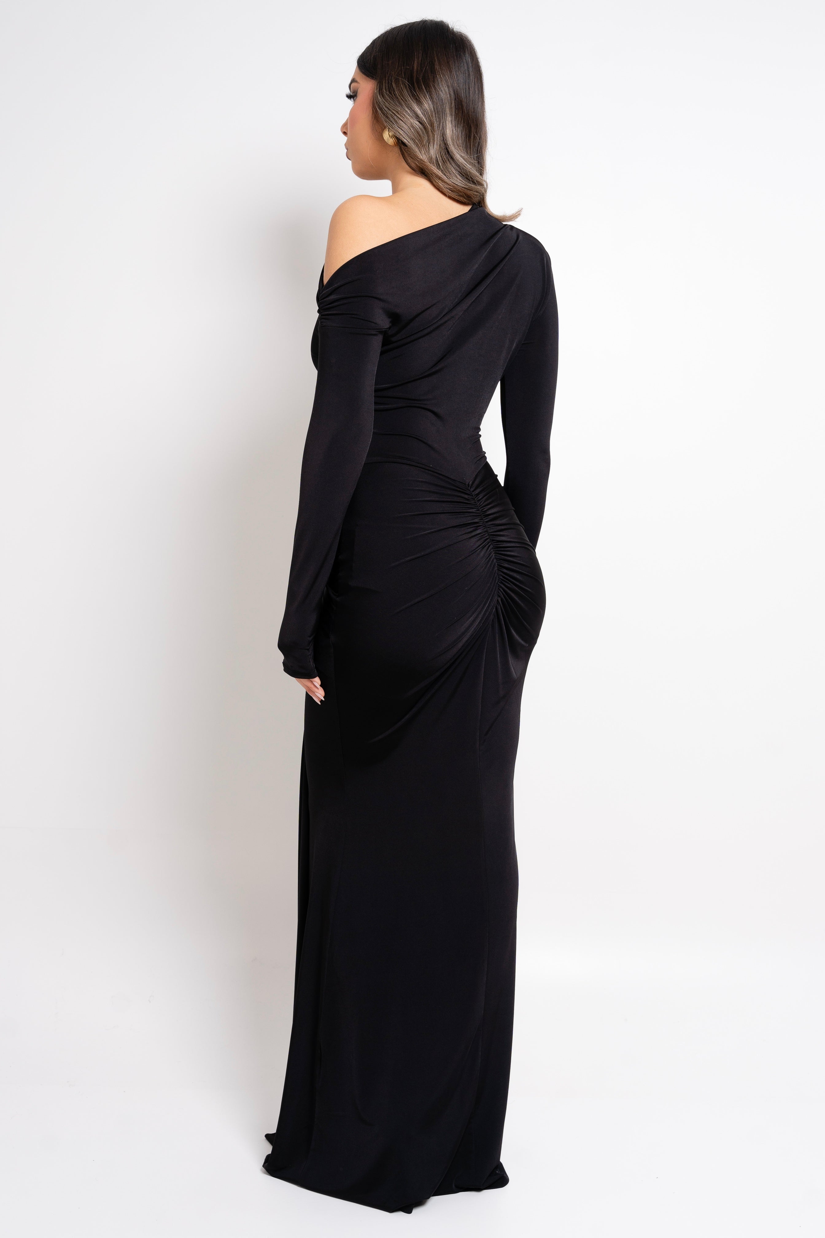 Sophisticated black dress with waist knot and gold accent.