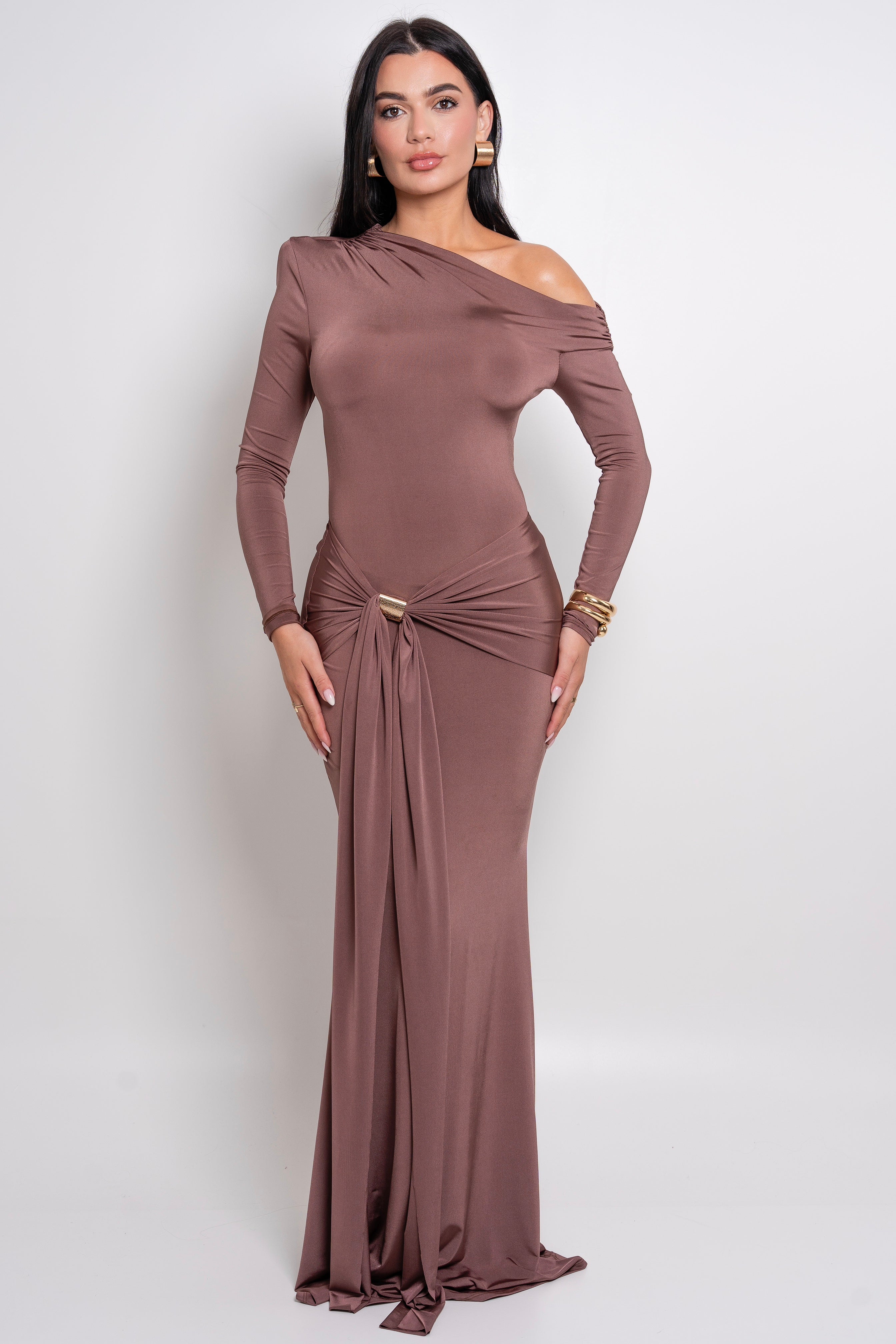 Elegant mocha-colored gown with a draped design and gold accent detail at the waist.