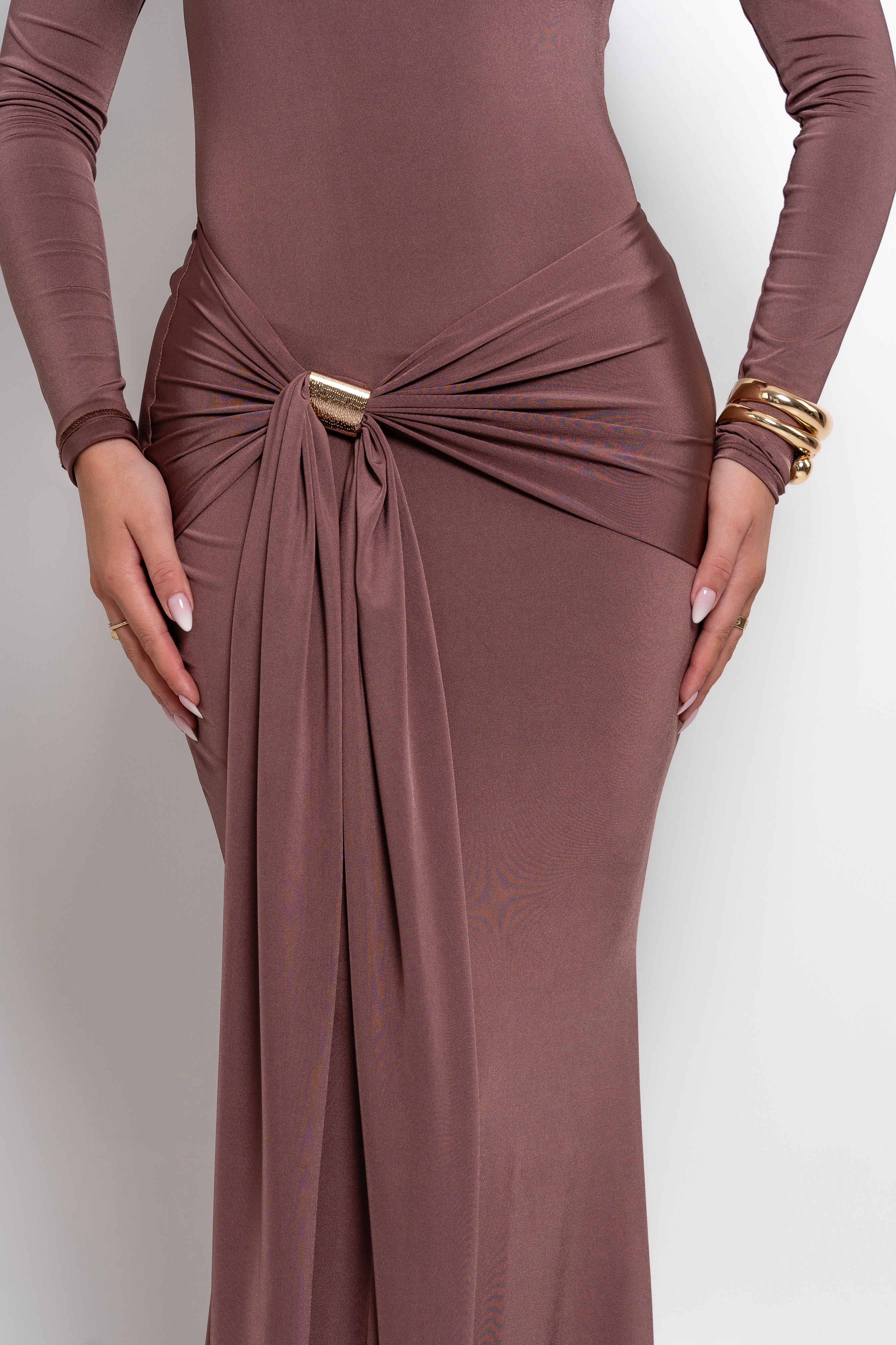 Refined mocha-colored gown with long sleeves and a flattering draped waist detail.