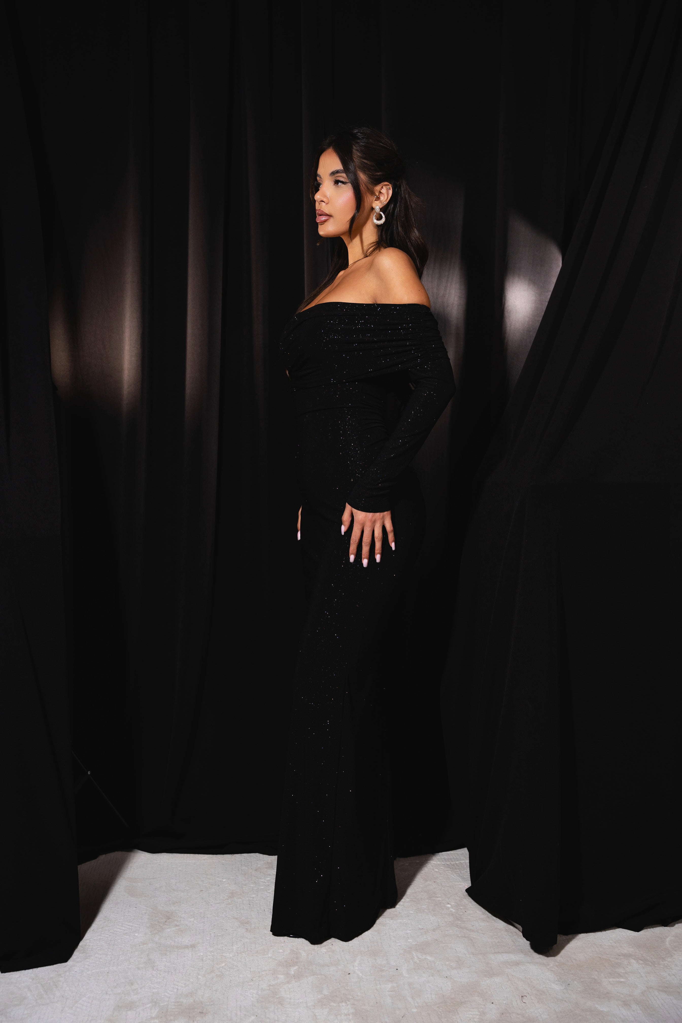 Alluring black evening gown with a classic drape