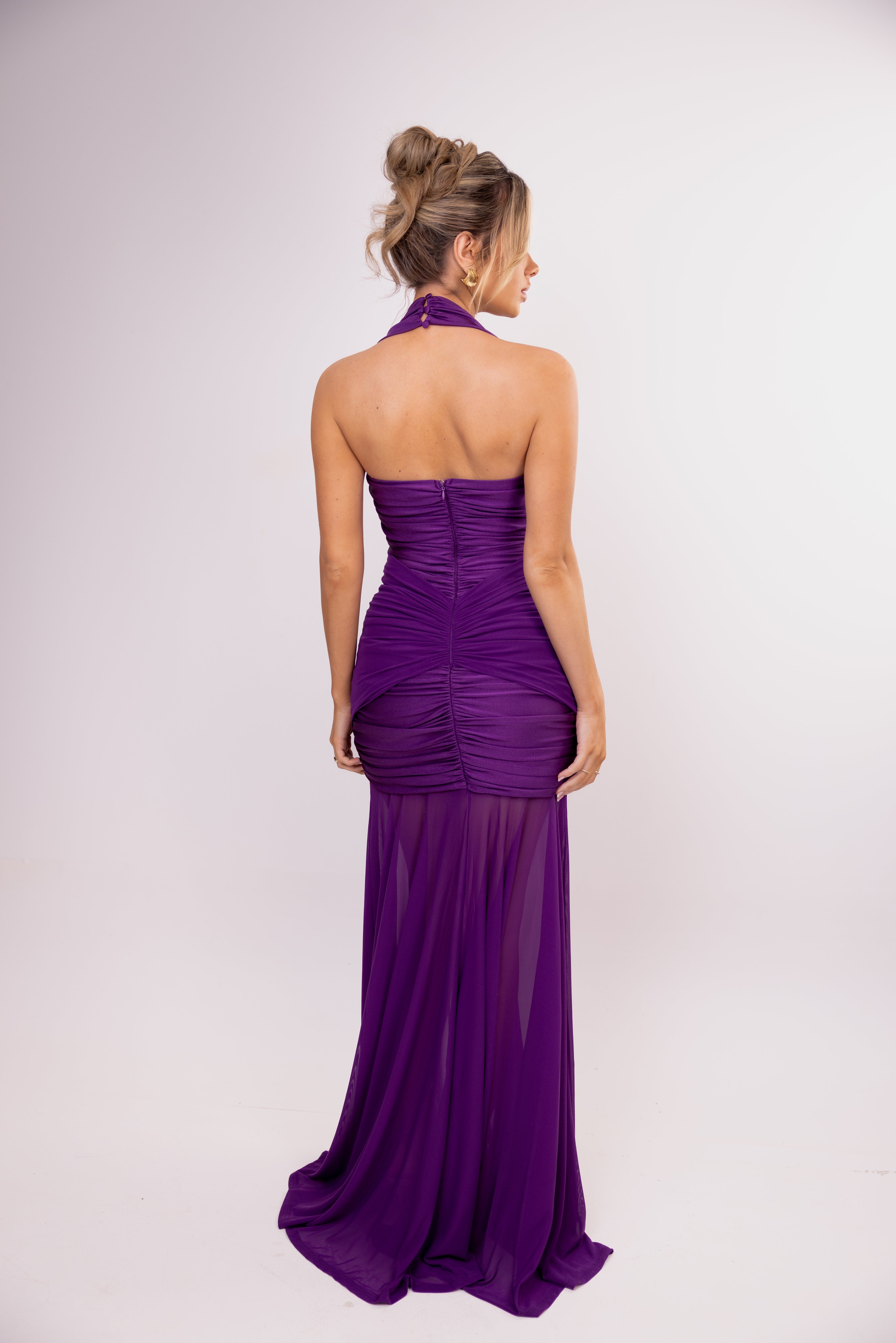 Woman wearing a purple evening gown on a white background