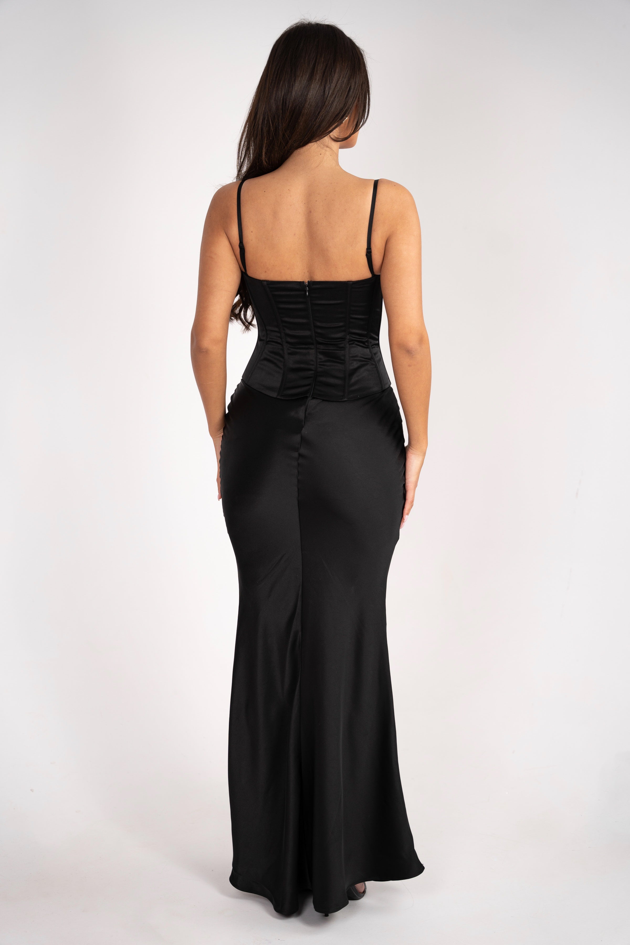 Back view of the Stela dress, featuring the smooth finish of the long skirt and soft texture of the mesh bolero.