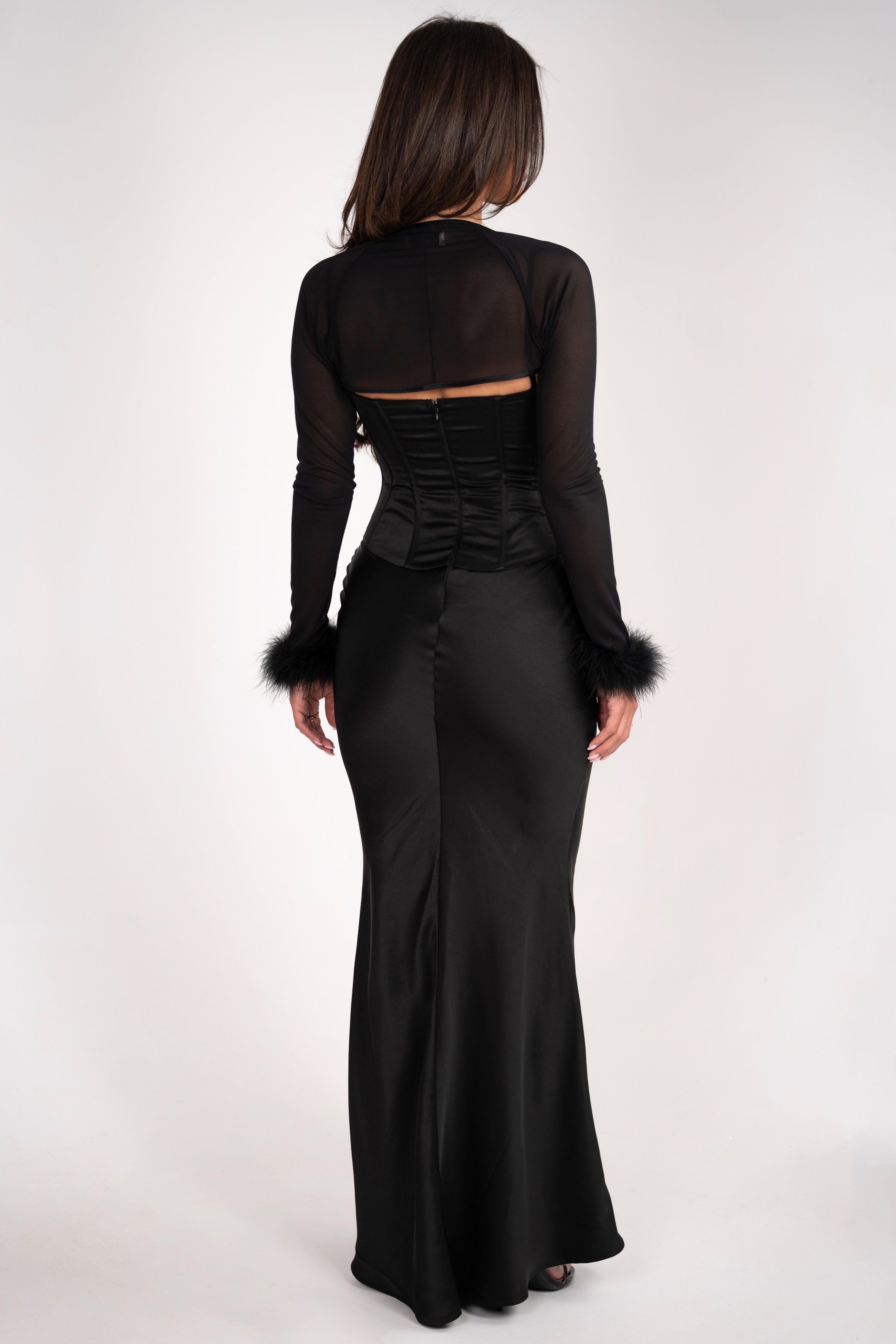 Back view of the Stela dress, featuring the smooth finish of the long skirt and soft texture of the mesh bolero.