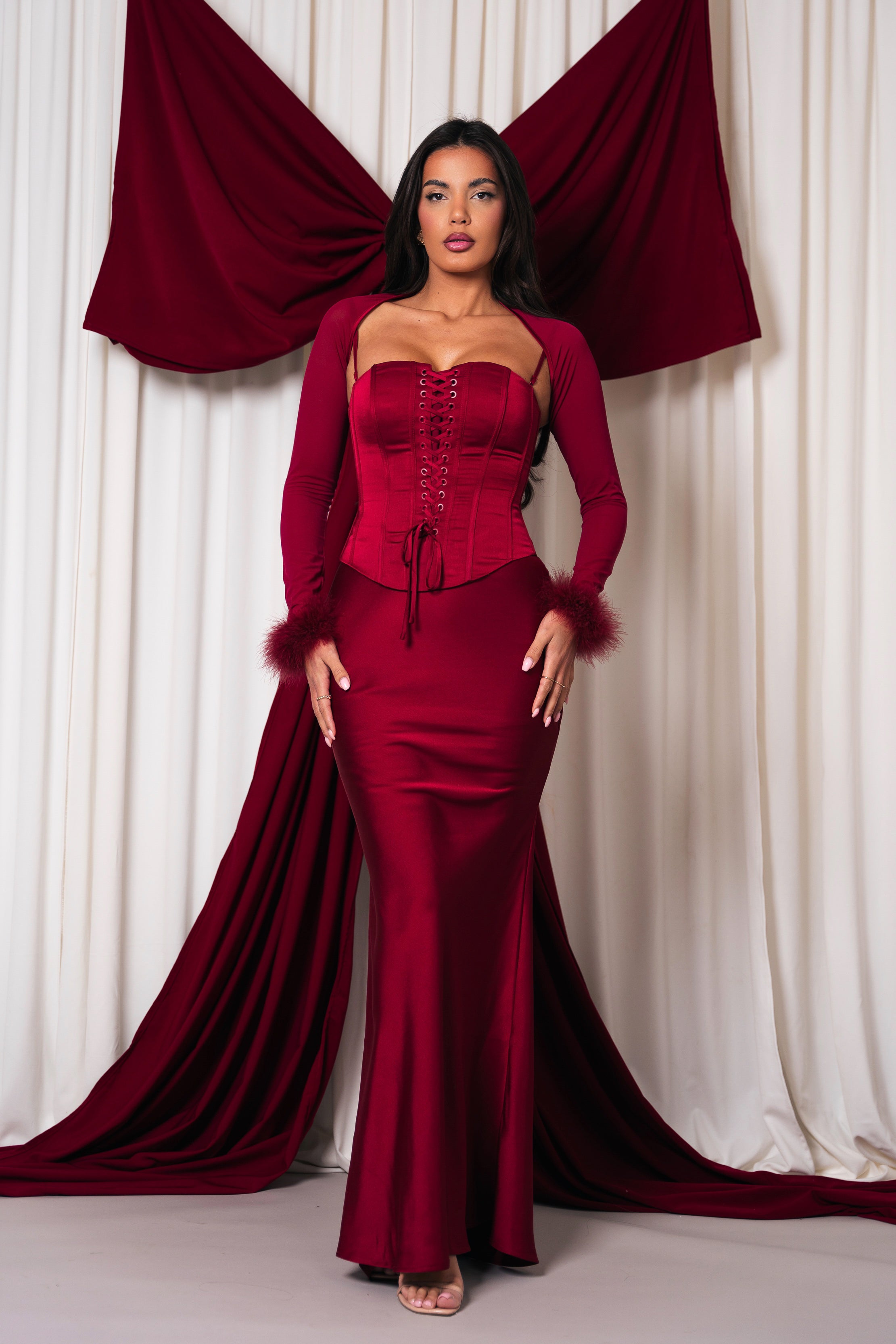 Stylish red set with a corset-inspired top and long skirt.