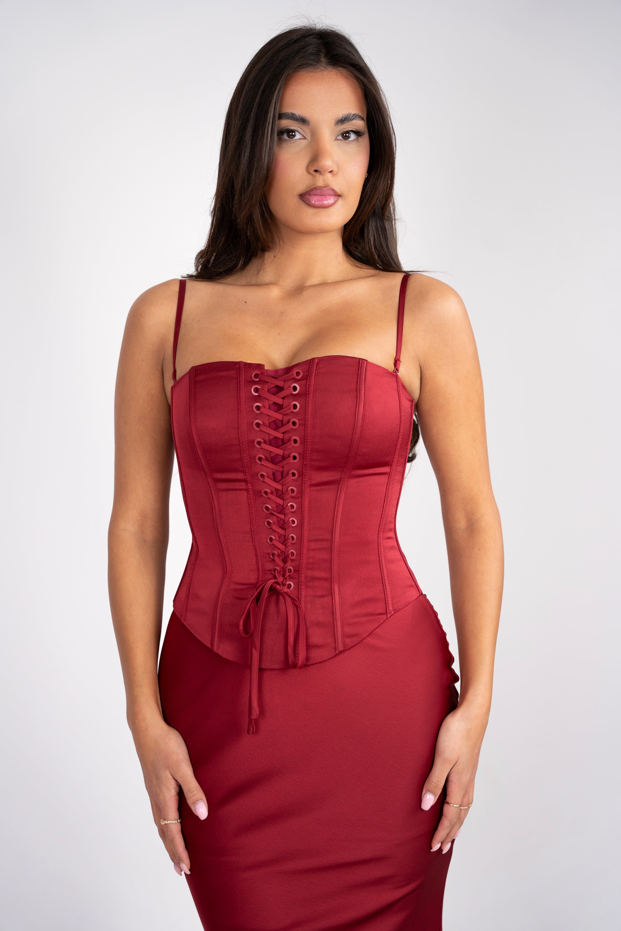 Fitted red corset with delicate straps and a satin skirt