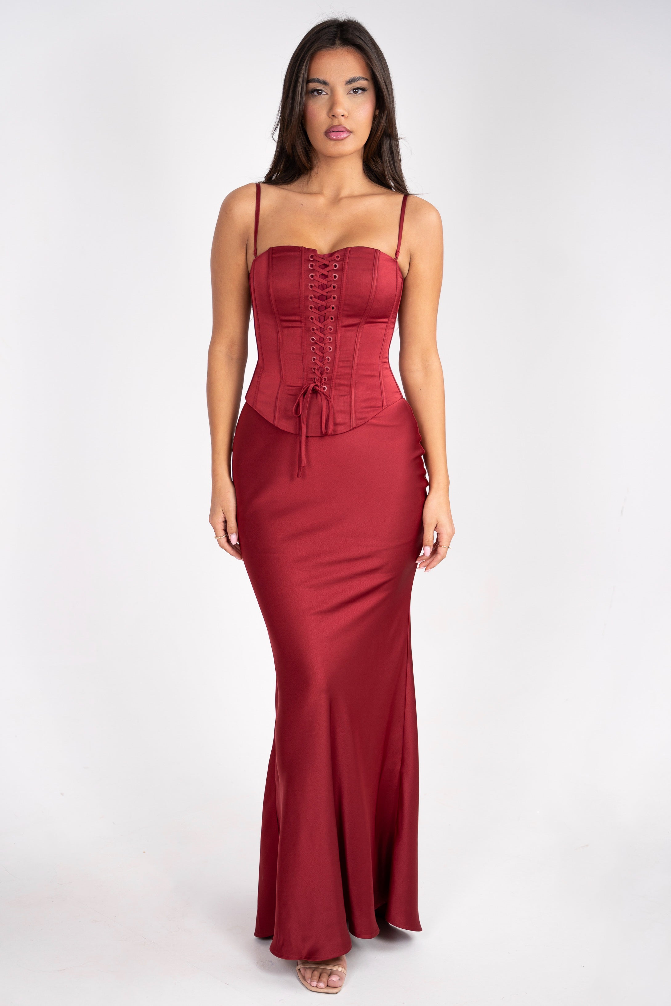 Elegant red dress featuring a corset-style bodice with lace-up detailing and thin straps.