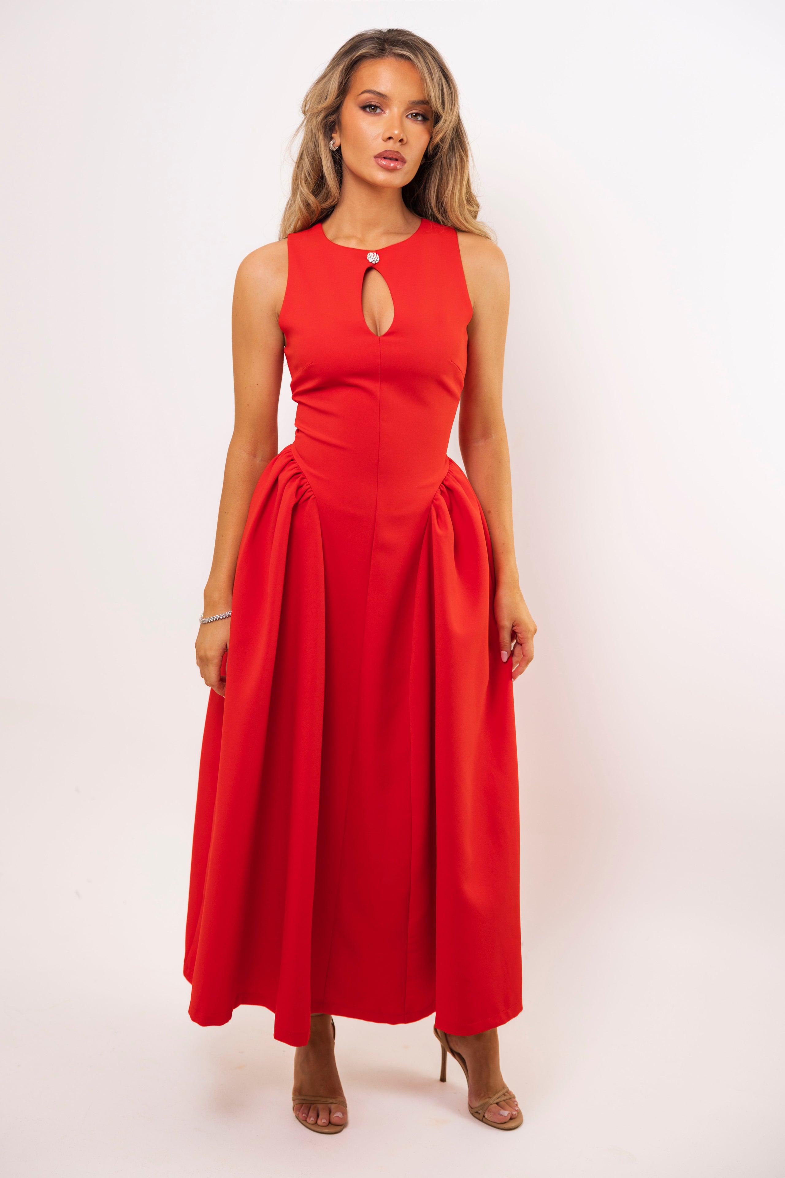 Elegant red A-line dress with structured waist and voluminous skirt.