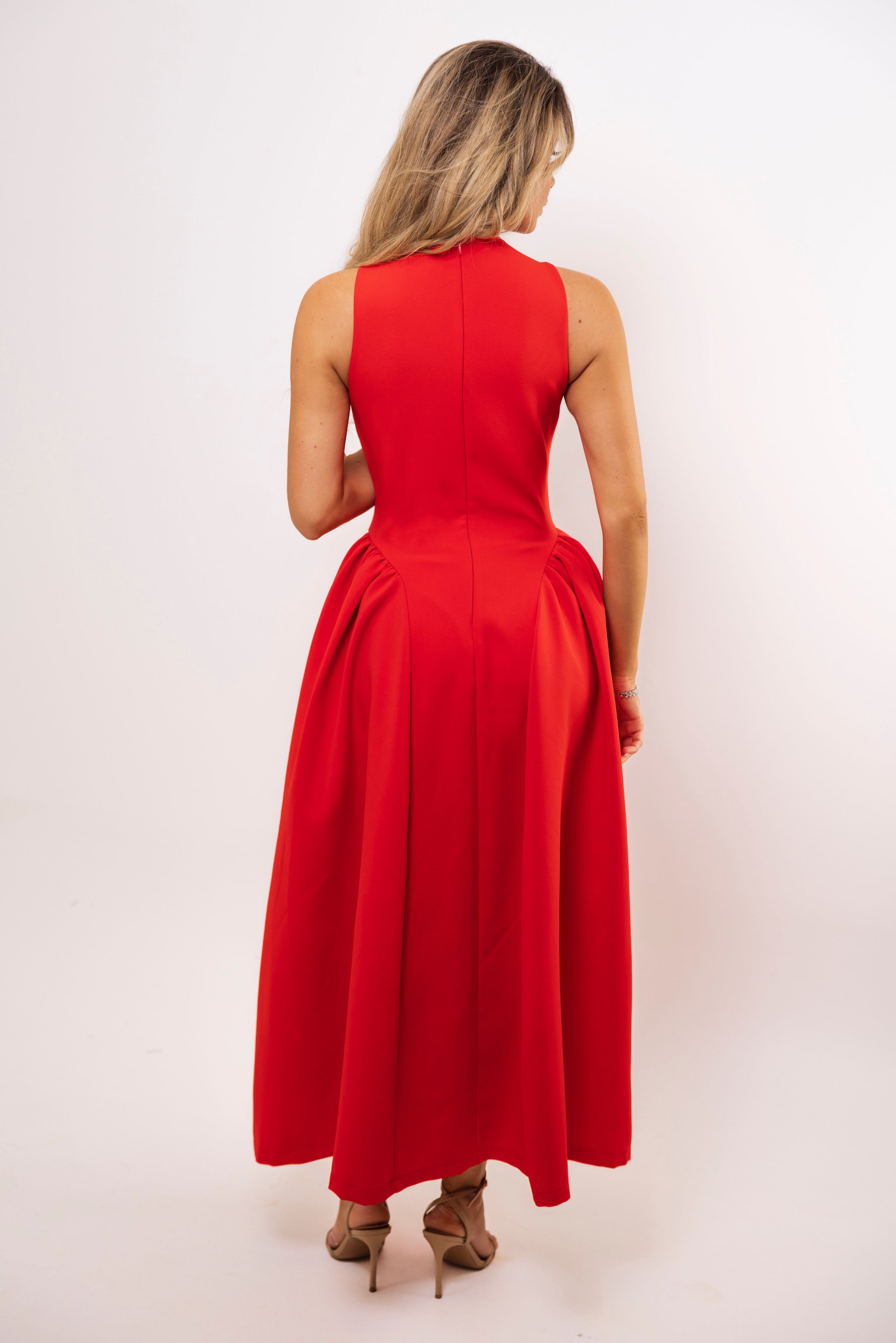 Back view of sleeveless red midi dress with flared silhouette.