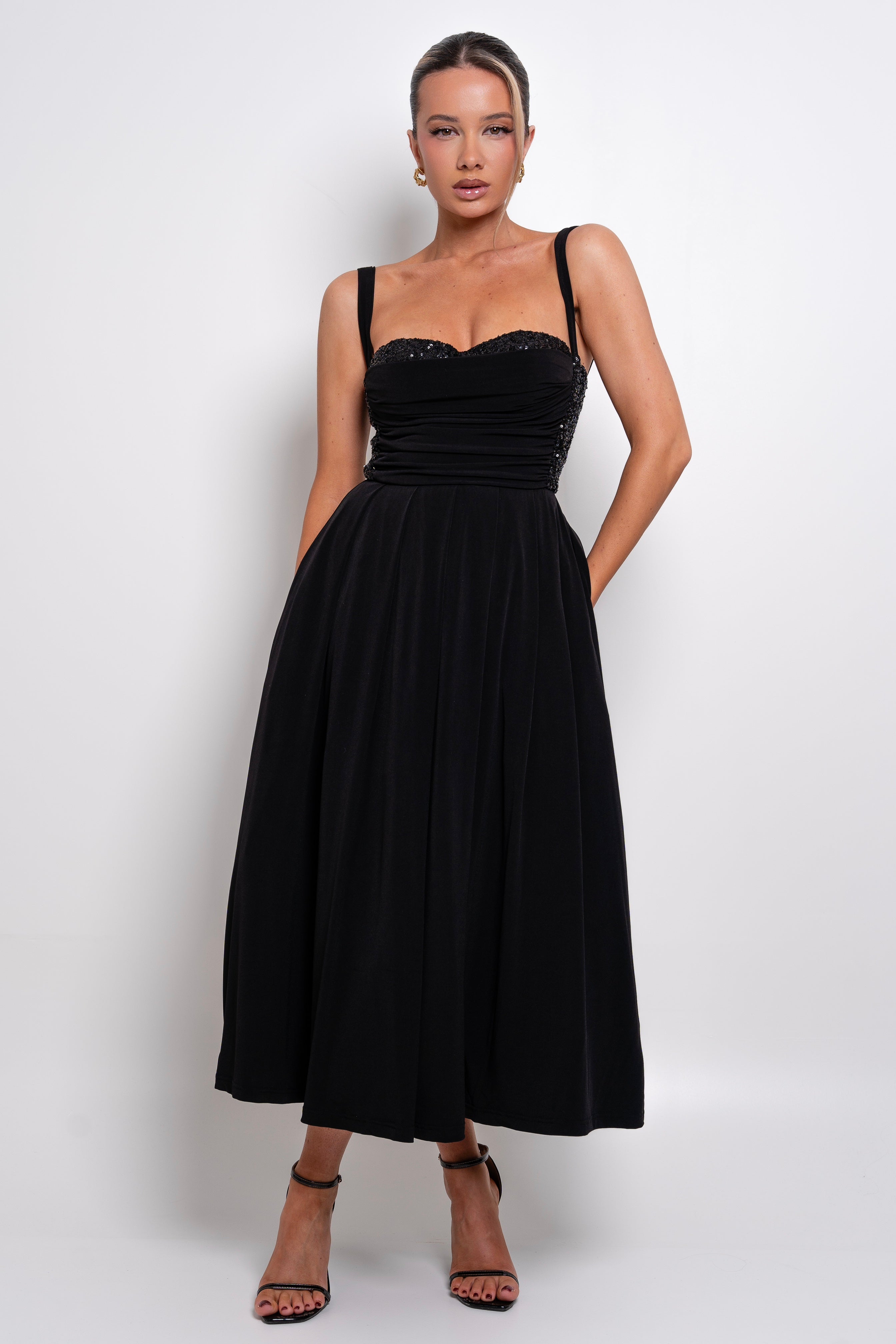 Elegant black midi dress with a sweetheart neckline and a fitted bodice.