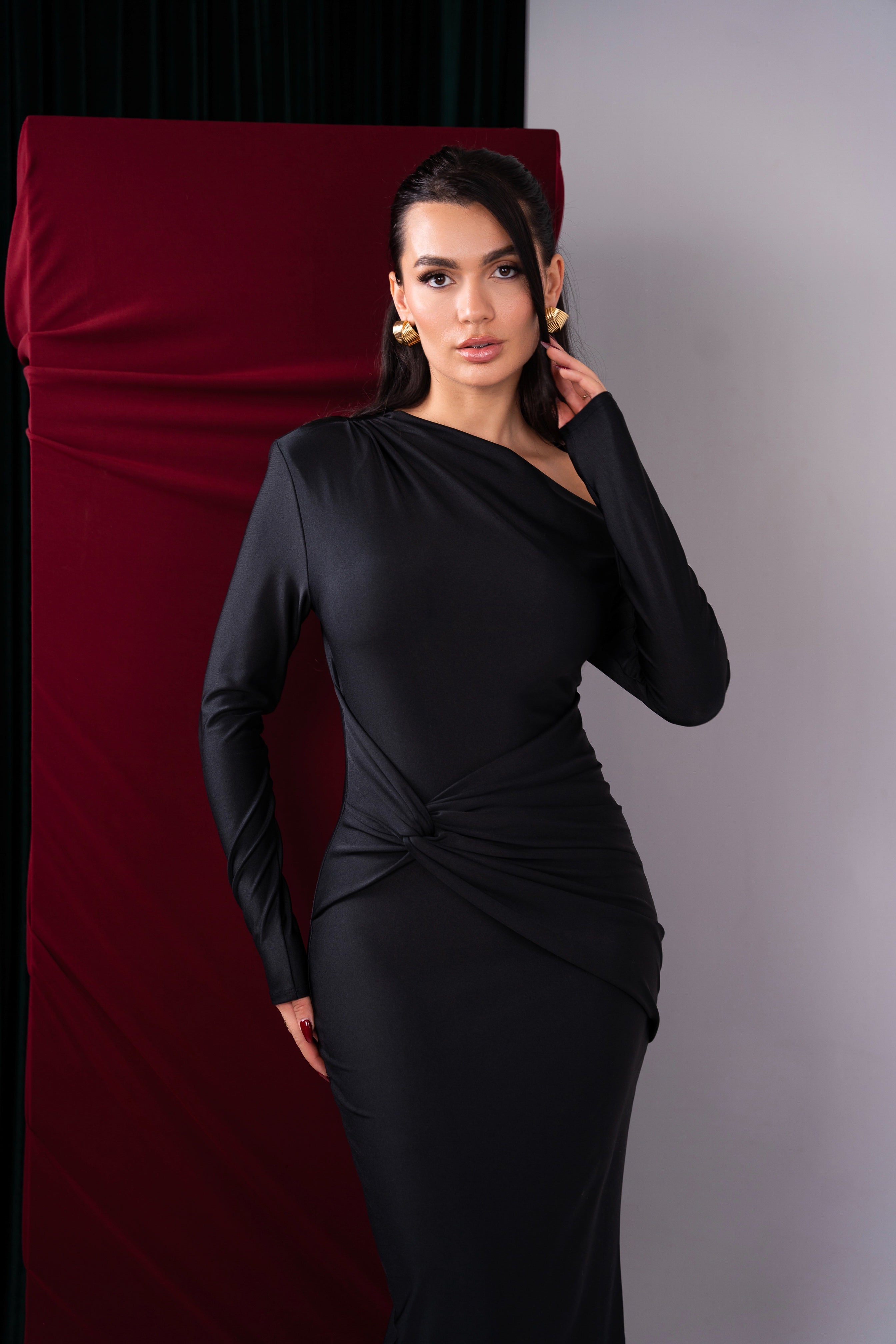 Sophisticated black dress with a form-fitting silhouette and asymmetrical neckline