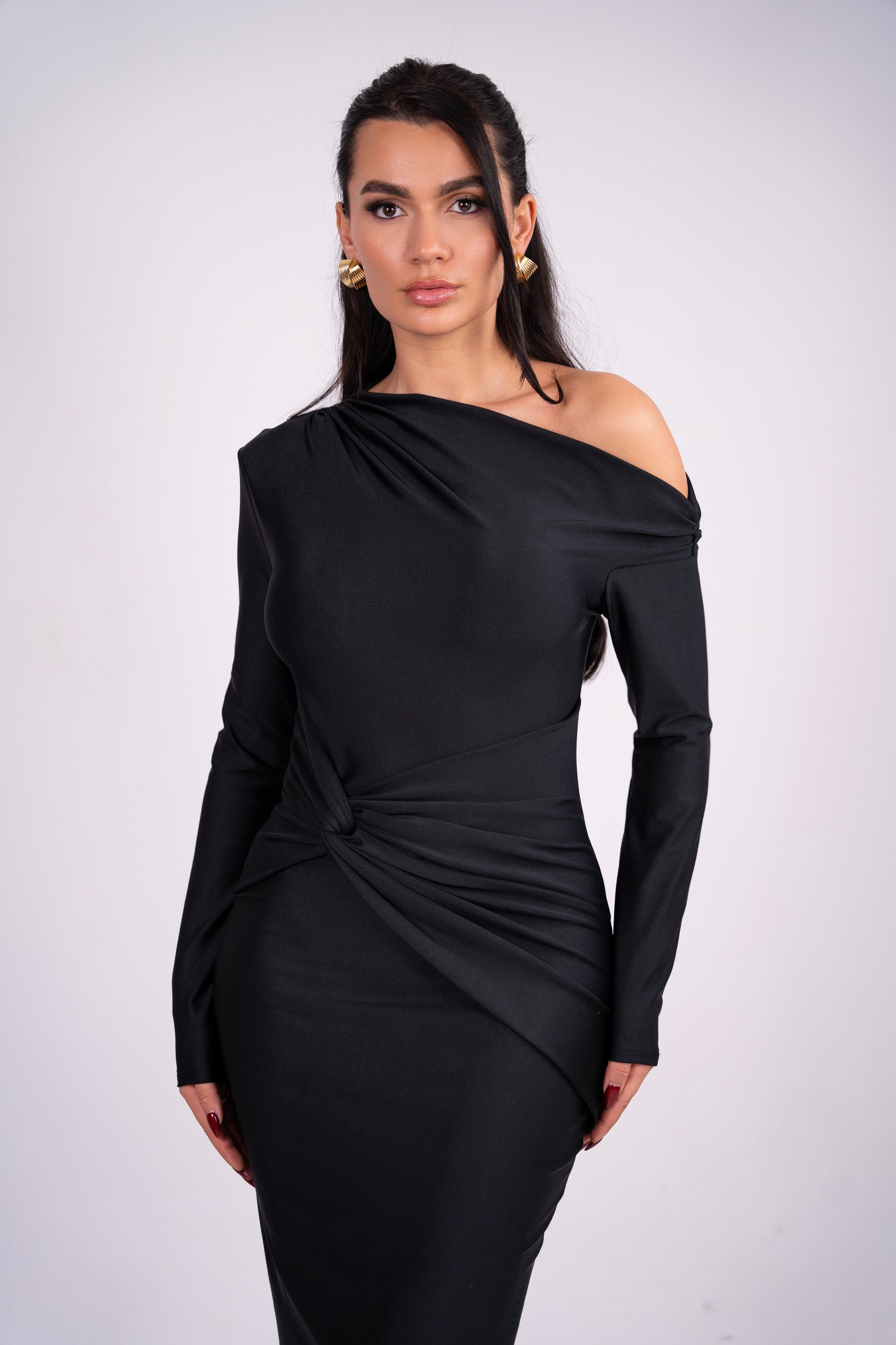 Stylish black evening dress with gathered details and long sleeves