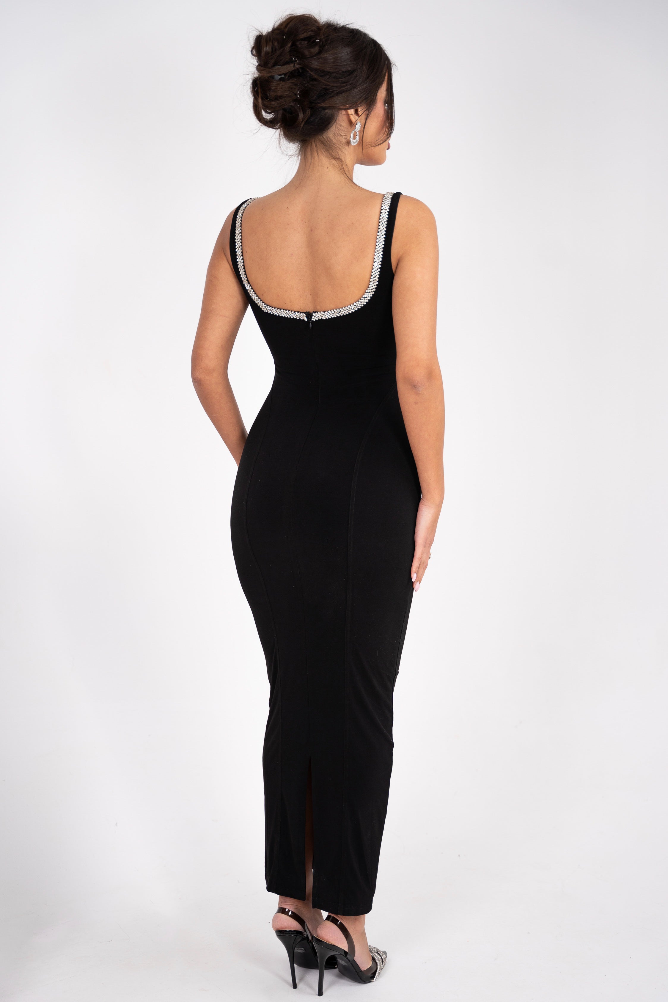 Form-fitting black dress with a square neckline