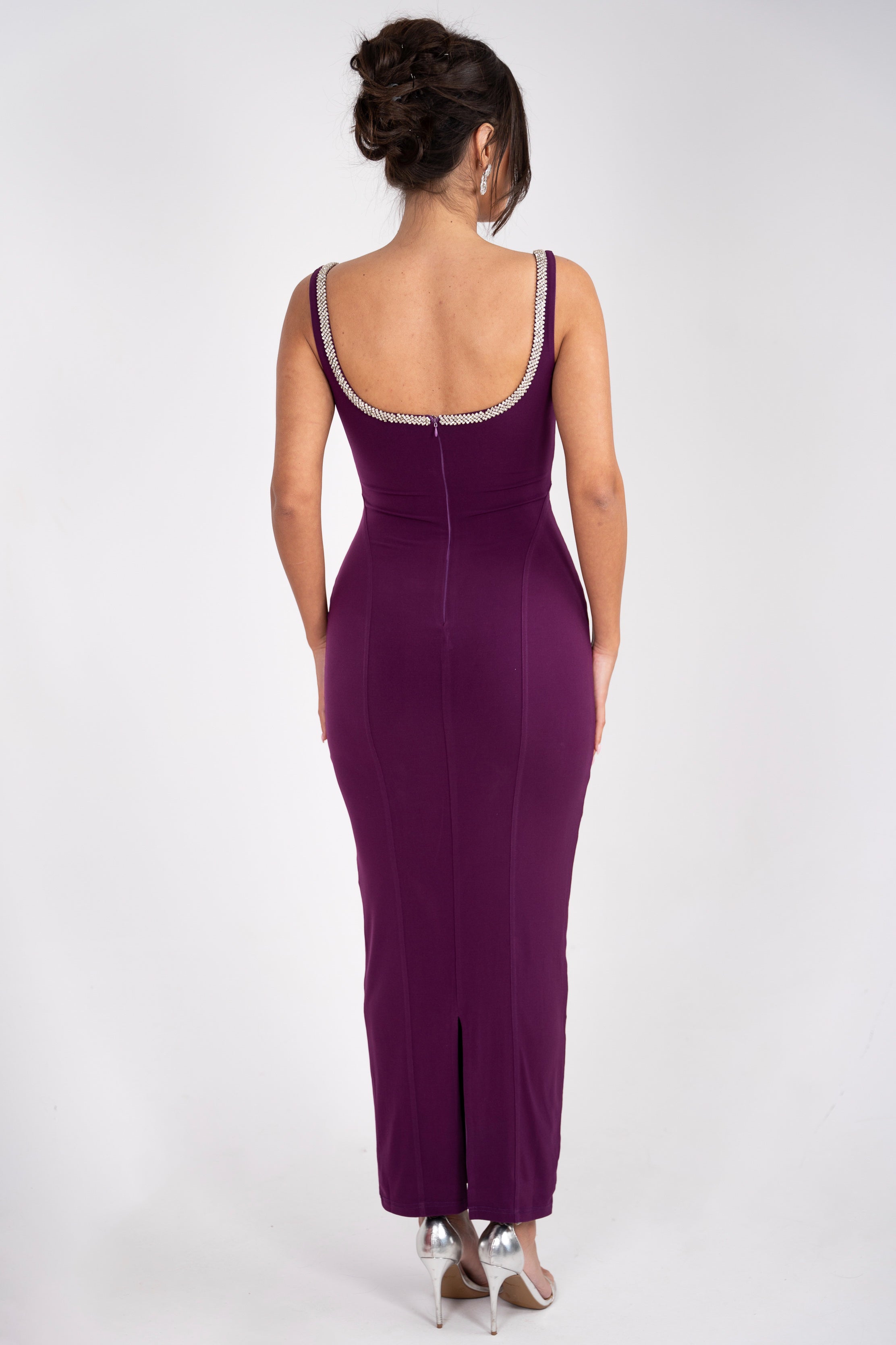 Rhinestone-accented neckline on a vibrant purple dress