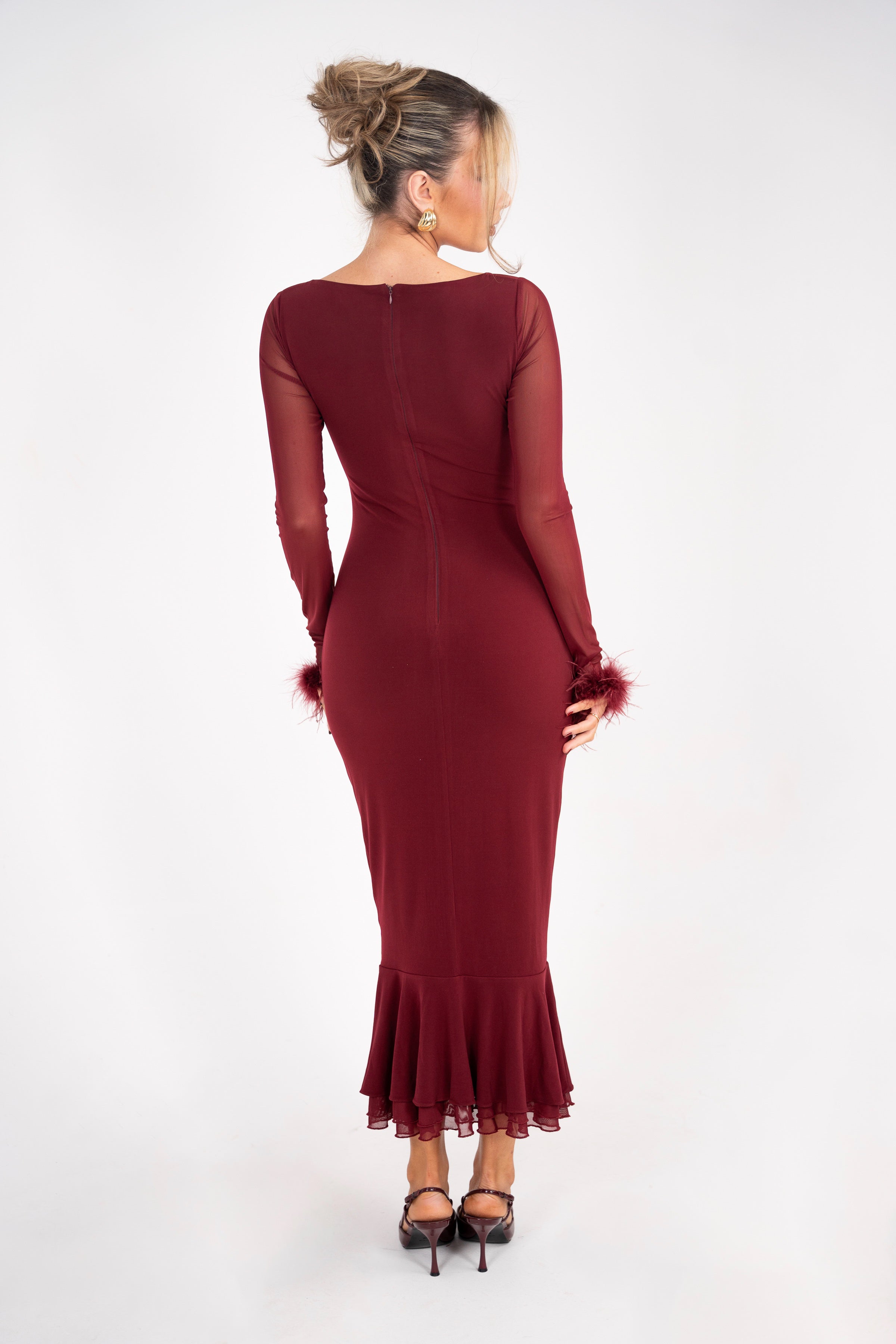 Deep red bodycon dress featuring sheer long sleeves and flared hem