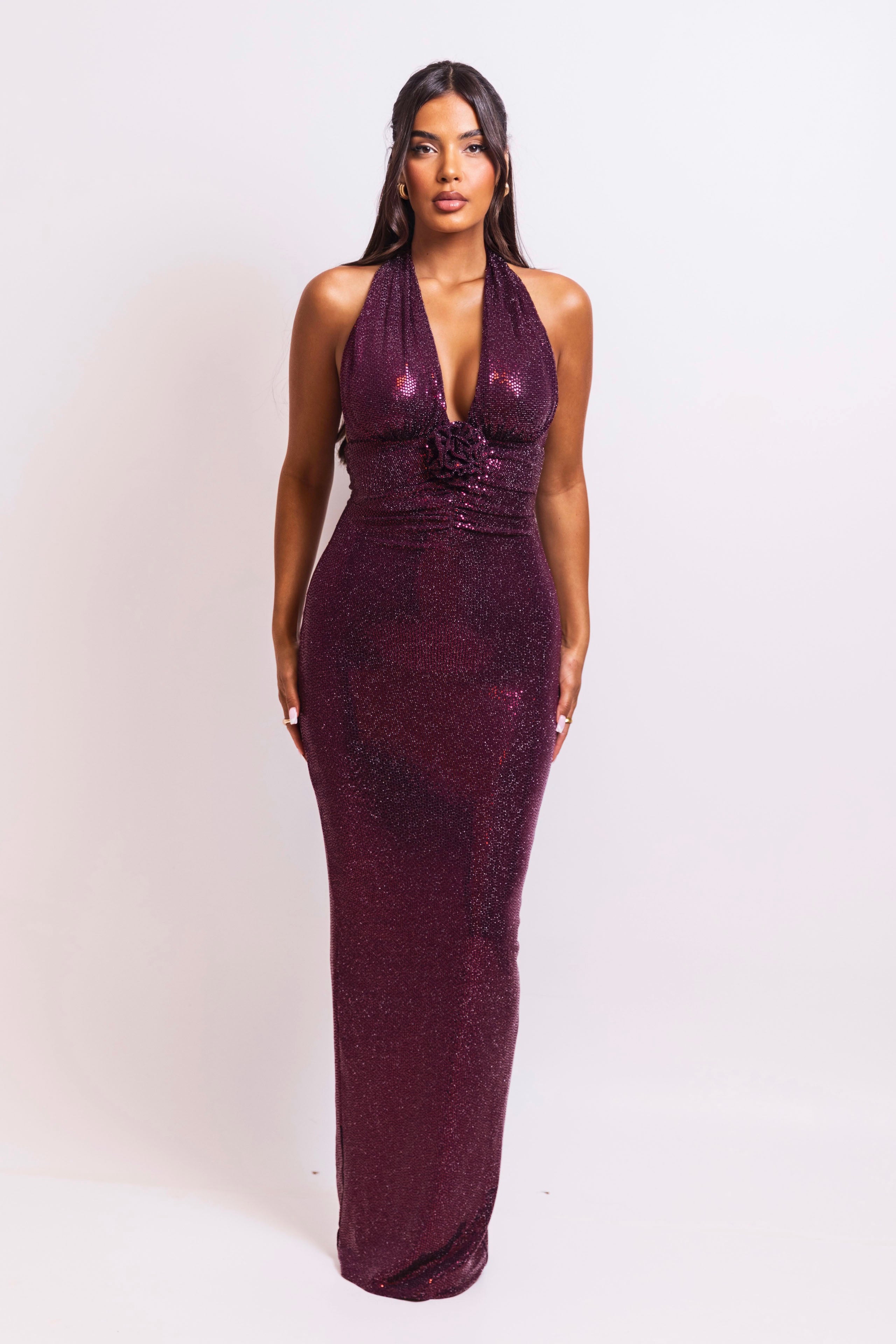 Form-fitting burgundy gown with soft shimmer and floral accent