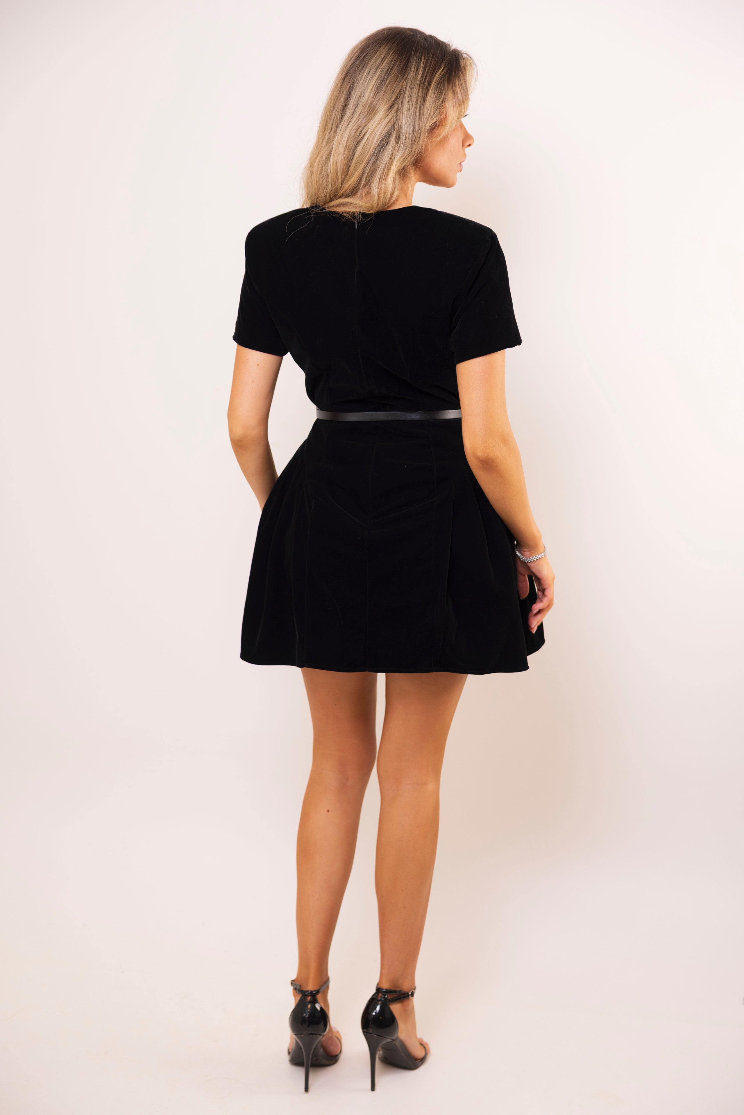 Chic velvet black mini dress styled with strappy heels.