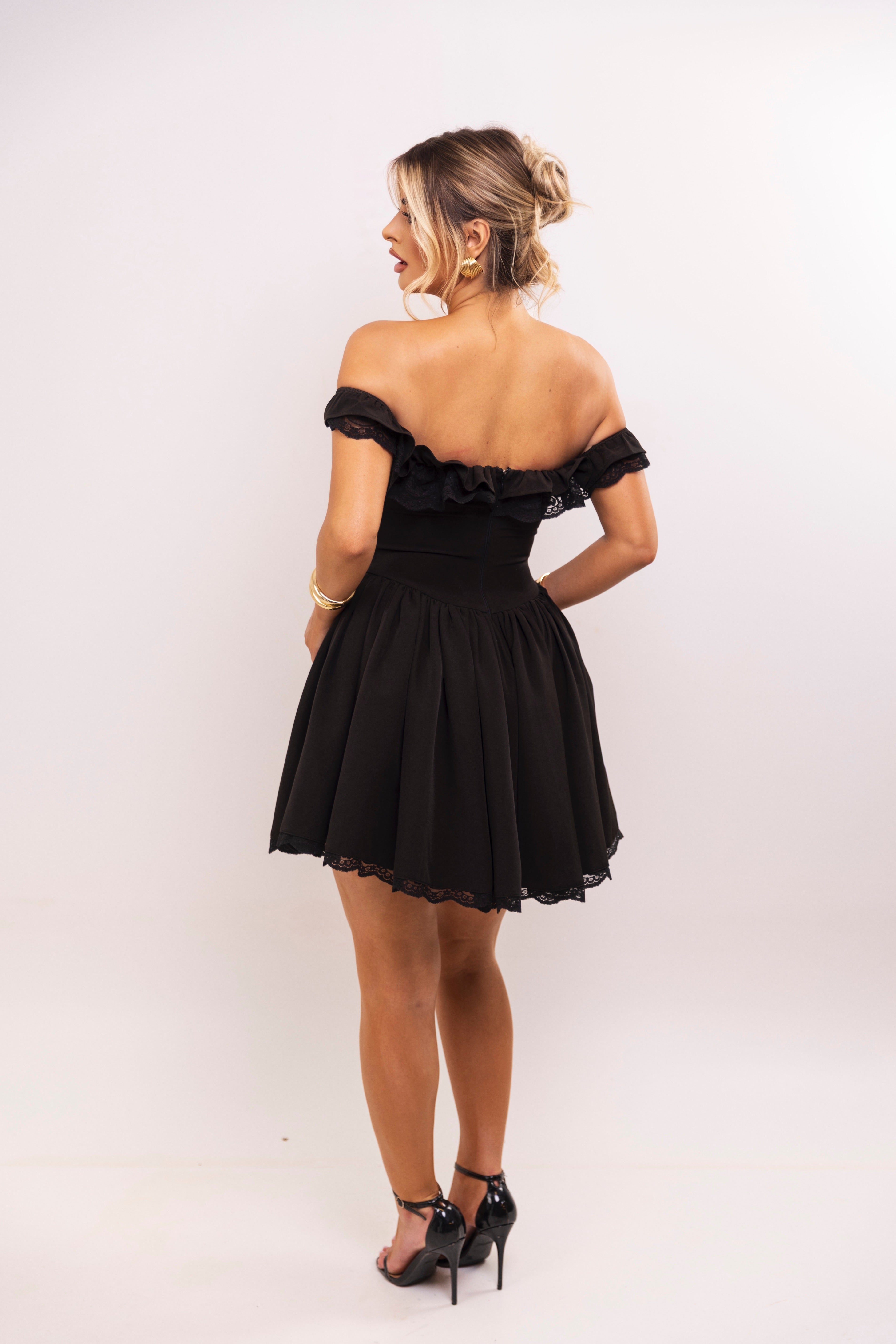 Corset-style black dress with flared skirt