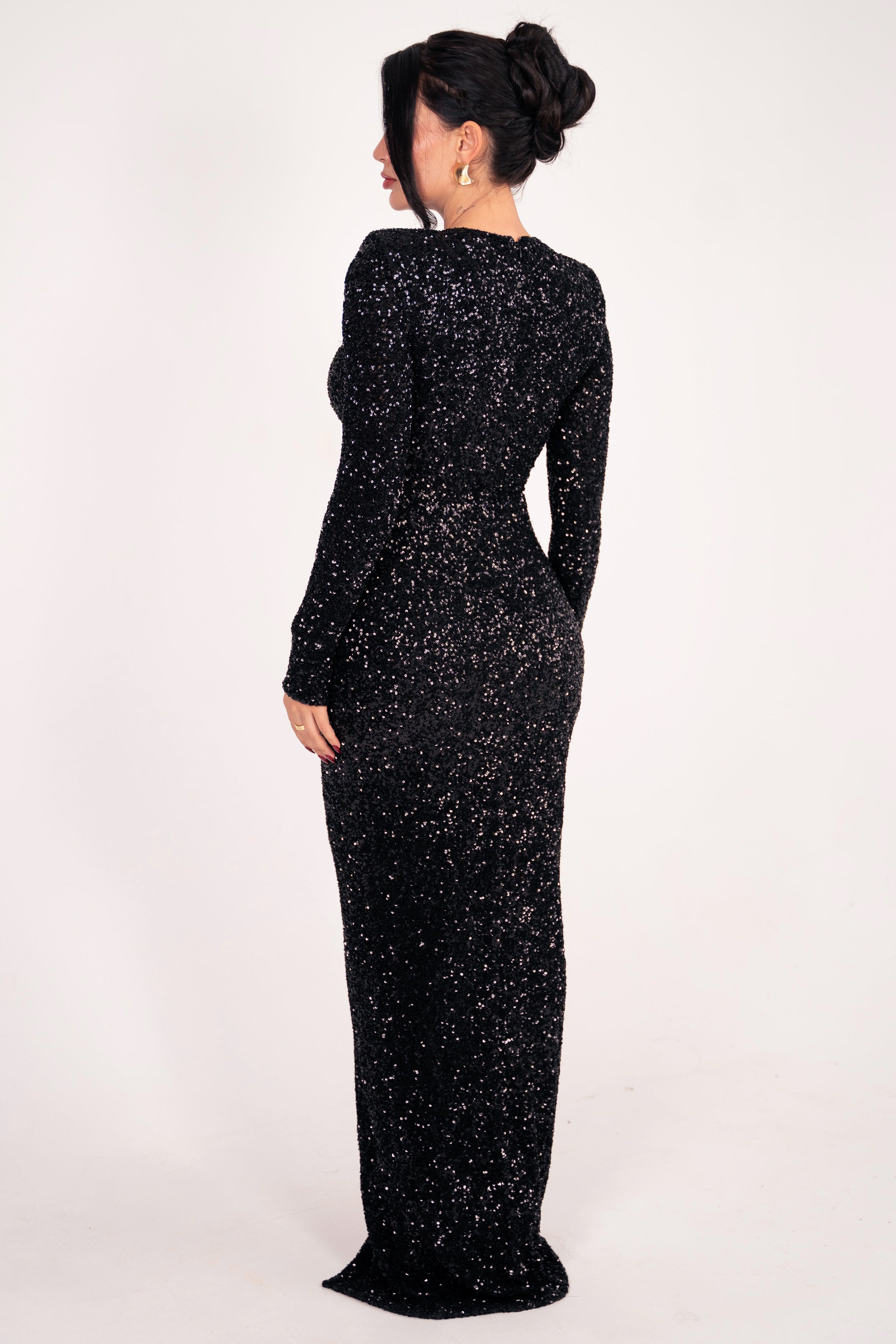 Glamorous black evening dress with a thigh-high slit and glittering details.