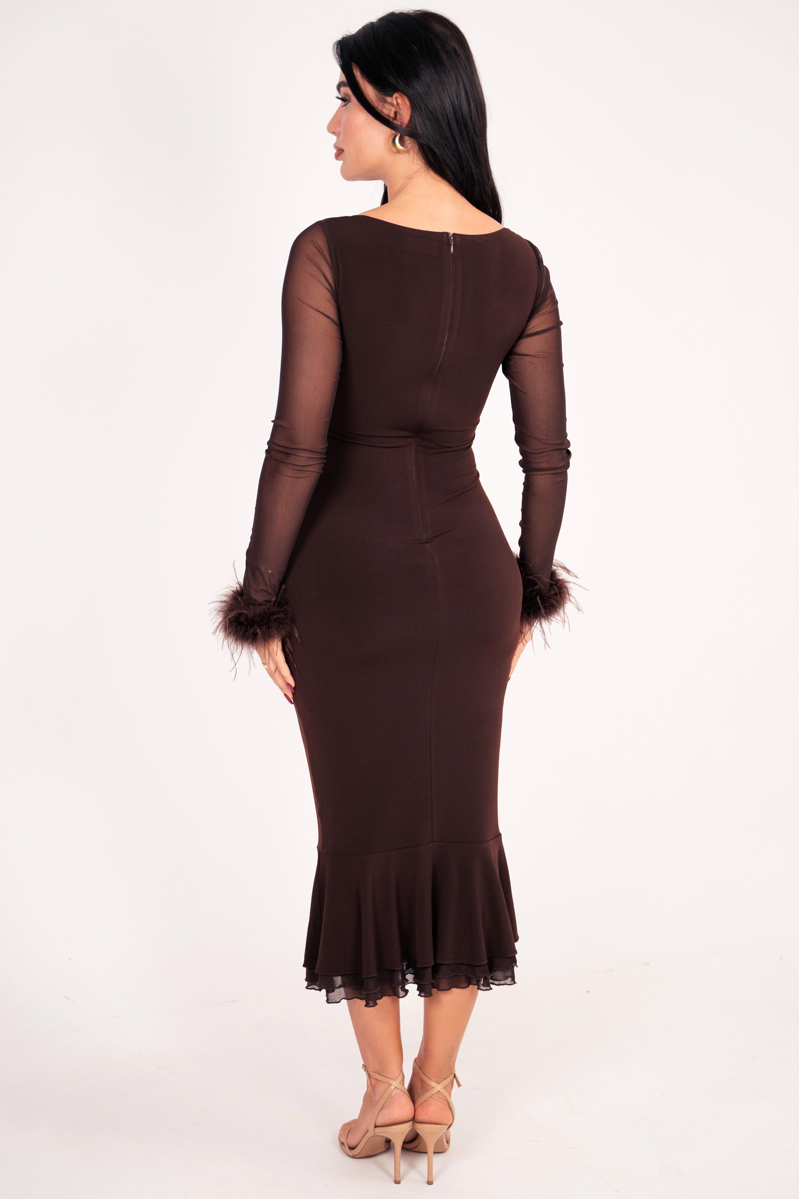 Fitted brown gown with delicate feathered cuffs and a subtle mermaid hem.