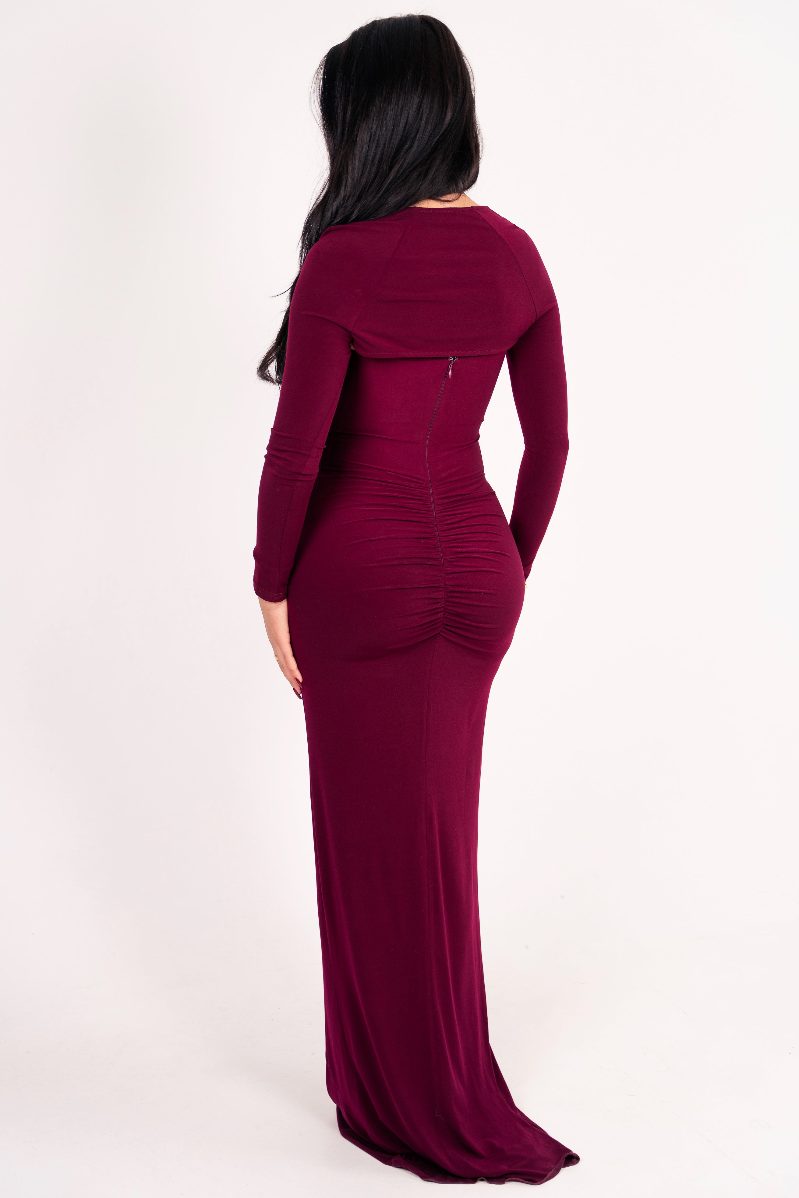 Long burgundy evening dress with dramatic ruffle detail and form-fitting design.





